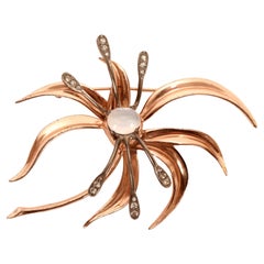 Brooch in sterling silver, gold and glass paste by Nettie Rosenstein. USA 1950.