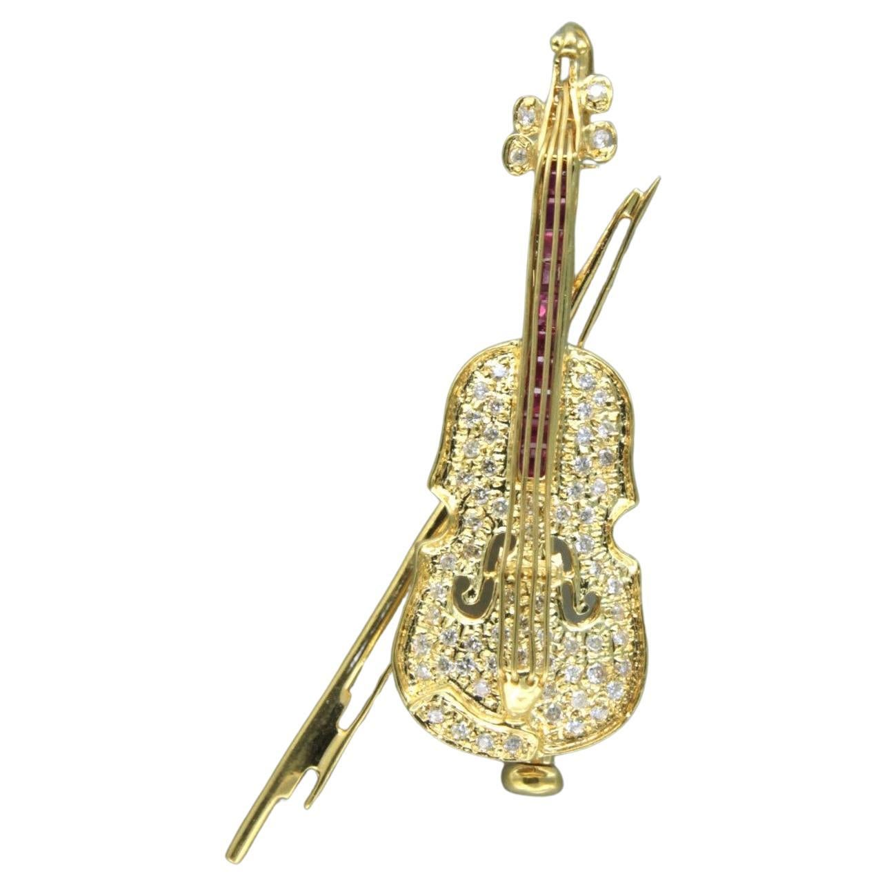 brooch in the shape of a violin set with ruby brilliant diamonds 18k gold