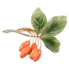 Brooch in the shape of a wild rose with coral, jade and diamonds.