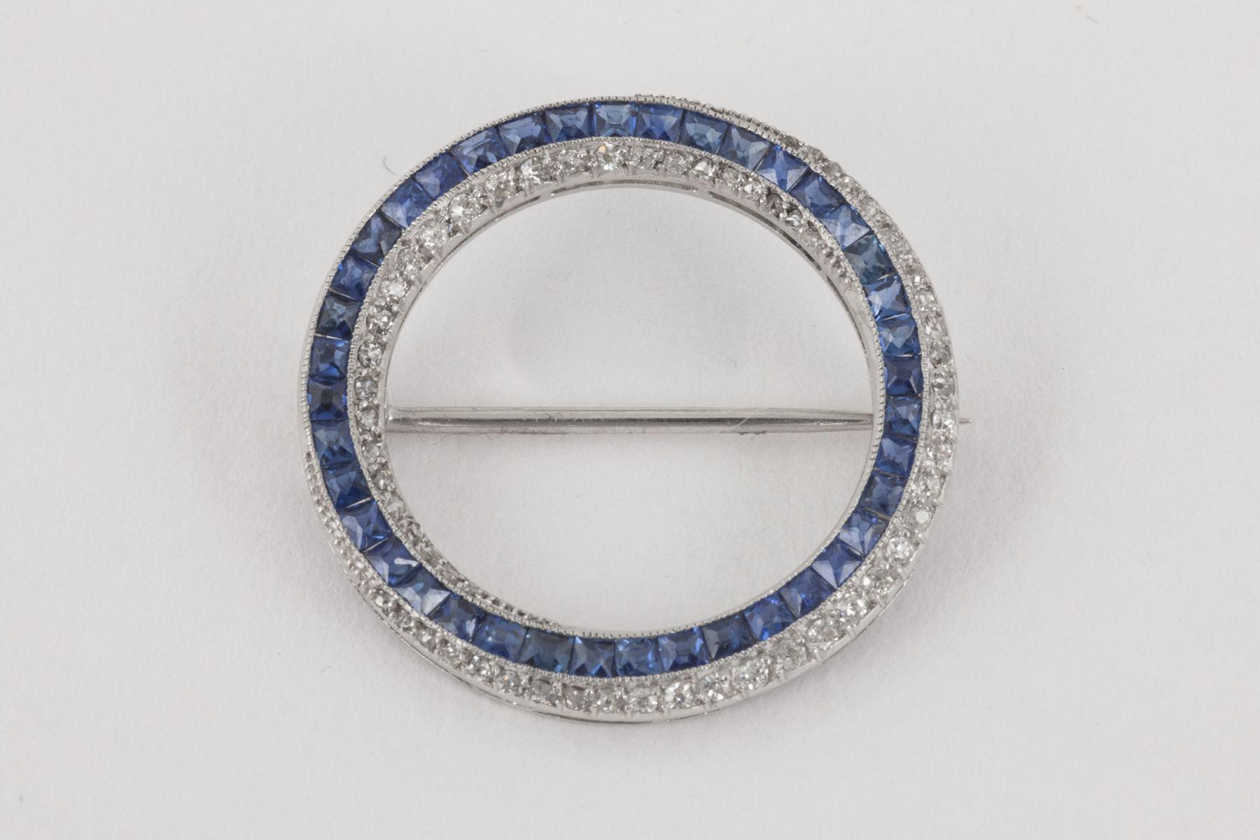 Round Cut Open Circle Brooch in Platinum, Diamonds & Ceylon Sapphires, English circa 1960 For Sale