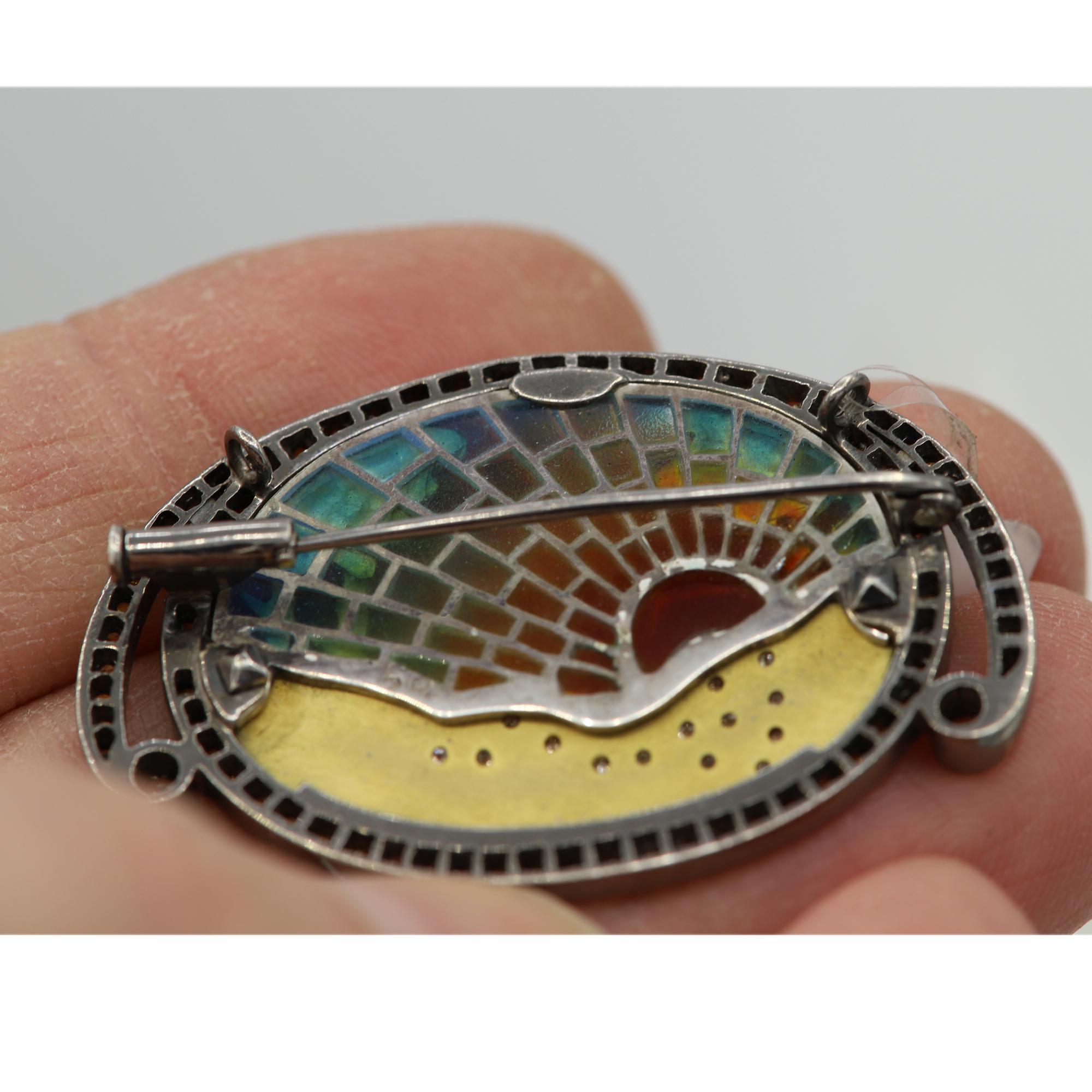 Hand made in Spain, a Brilliant Artistic fire Enamel Brooch -Necklace
very colorful made with Diamonds and Sapphires.
Approx size 50 x 35 mm or  2' Inch
can be fitted with a chain for necklace wear - Chain - Not included.
Total Diamonds 0.31