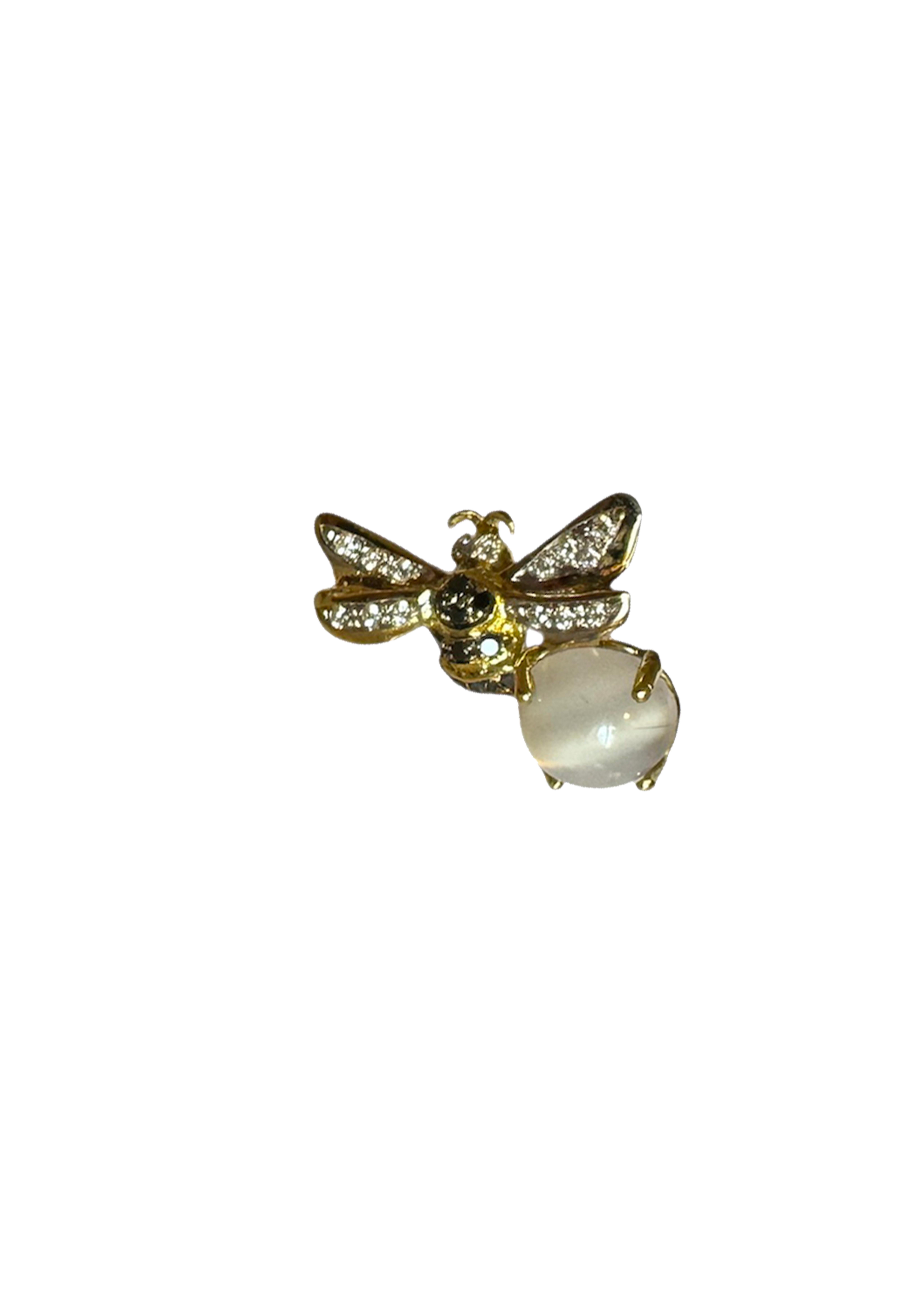 Rossella Ugolini bee pin brooch is handcrafted in 18k yellow gold white diamonds, black diamonds and round cut Moonstone.  
Dimensions: 0.79 in. (2 cm) x 0.79 in. (2 cm).
These 18K Yellow Gold Pin Brooch, adorned with ct. 0,10 white Diamonds and 0.9
