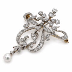 BROCHE - Schumann's Sons : fleur victorienne ancienne ornée d'un diamant de 4,25 carats et de perles.
