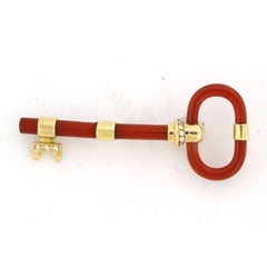 Brooch shape of a key with carnelian and diamond up to 0.20ct 11.5 gram 18k gold