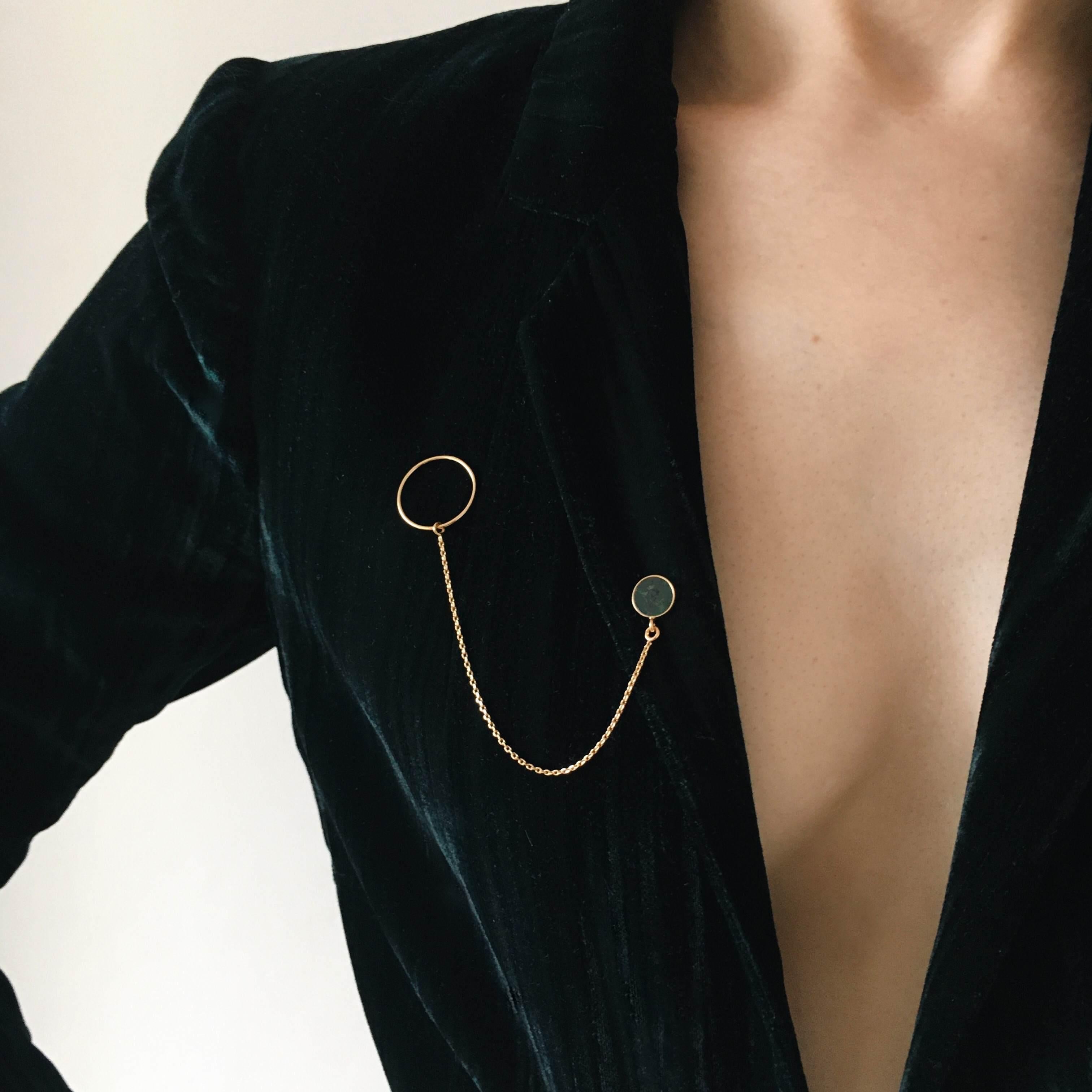 Gold brooch with stone, chain and circle will add a touch of extravagance to your styling. It looks beautiful attached to the lapel of a jacket or coat. If this is to be your first experience with this type of jewellery, this model will be perfect.