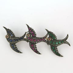 Brooch with ruby, sapphire, emerald and single cut diamonds gold and silver