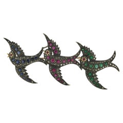 Brooch with ruby, sapphire, emerald and single cut diamonds gold and silver