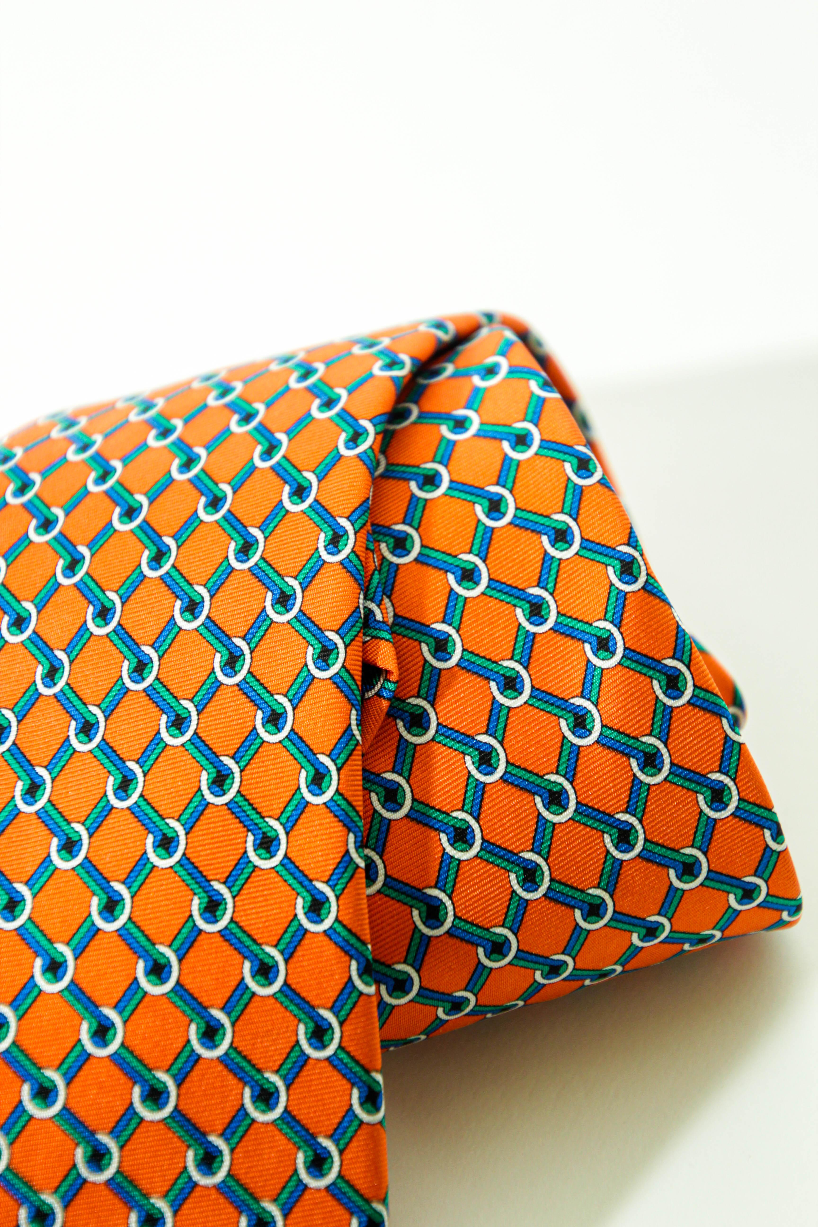A whimsical Brooks Brothers men's silk tie. 
The tie is handmade in the USA from 100% silk. The tie features a multi-colored orange Hermes Green and blue geometric design.
In very good preowned condition . 
Tagged Brooks Brothers Made in USA 100 %