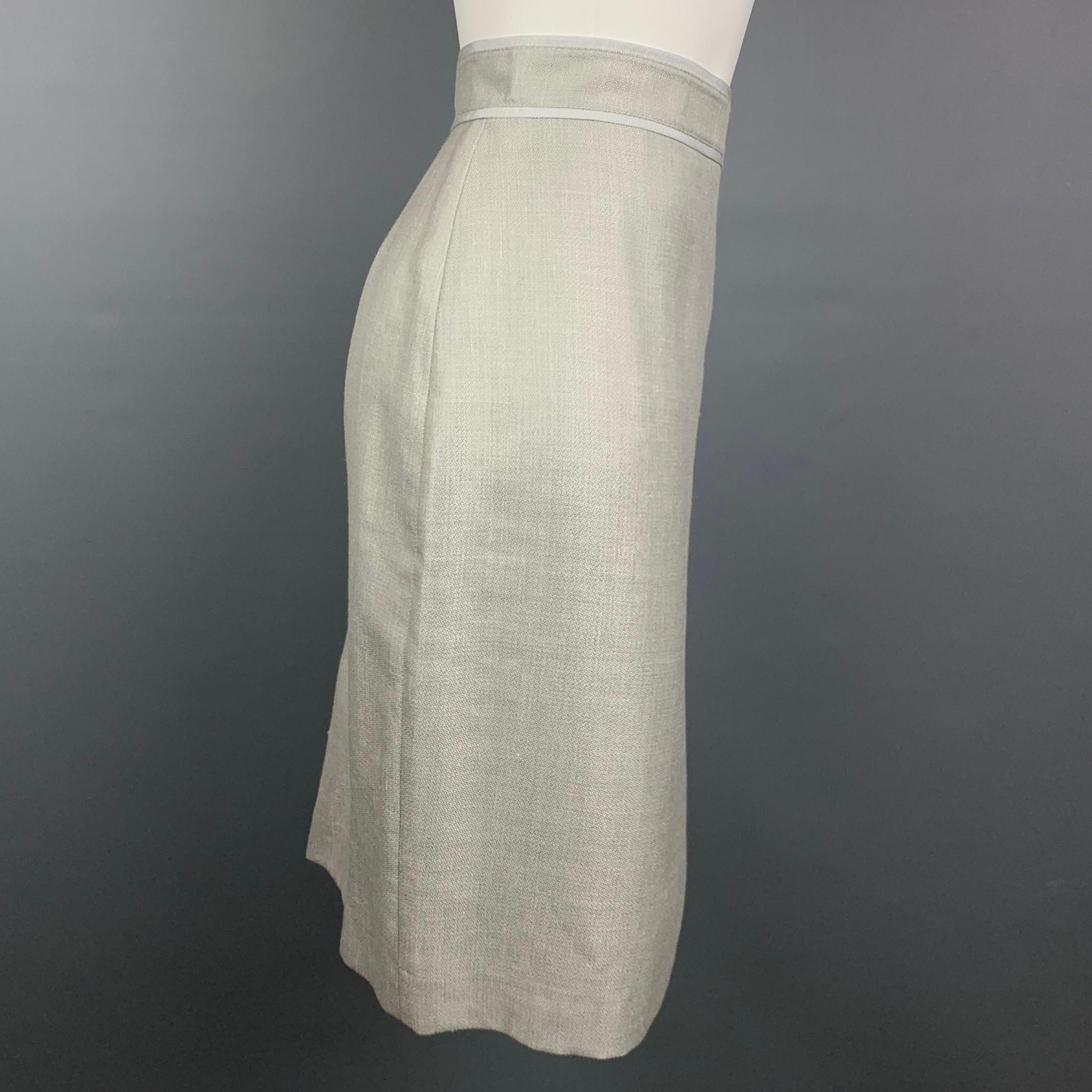 BROOKS BROTHERS skirt comes in a light gray wool blend with a slip liner featuring a pencil style, back pleats, and a back zip up closure. Fabric by Loro Piana.

Very Good Pre-Owned Condition.
Marked: 6
Original Retail Price: