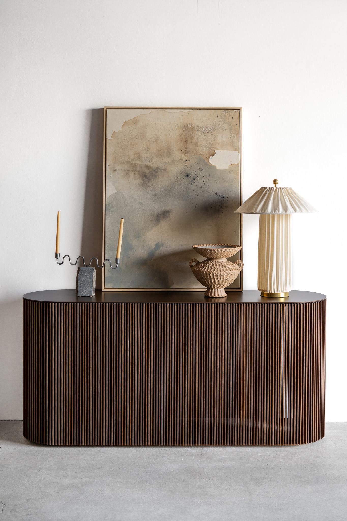 La console Brooks est un équilibre parfait entre l'affirmation et la subtilité, une marque de luxe décontracté qui définit le design californien contemporain. Dotée d'un extérieur nervuré distinctif avec des lattes de bois verticales alignées avec