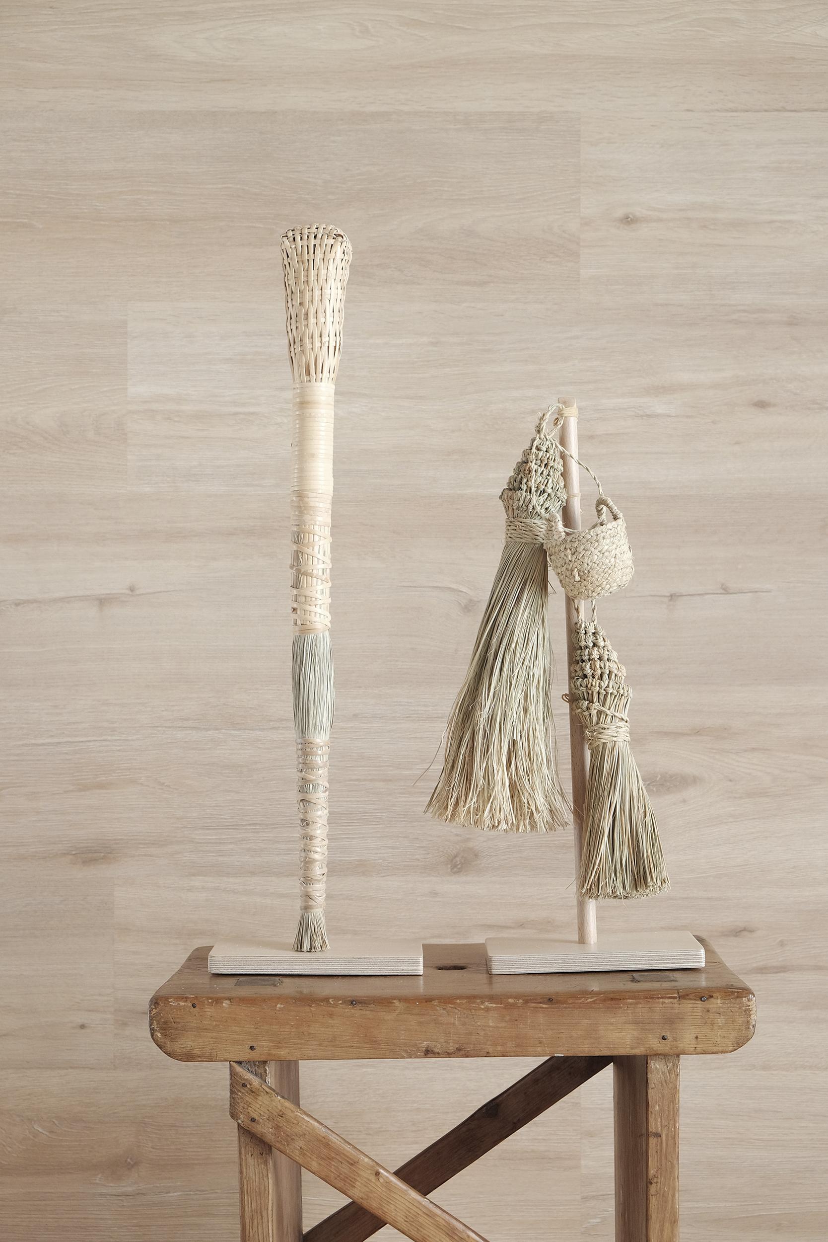 A figurative brooms nd basket artwork crafted in Spain by Gabriela de Sagarminaga. Two historical objects pertaining to the daily tasks performed in our homes to create the right order: cleanliness and personal satisfaction. A Spanish culture