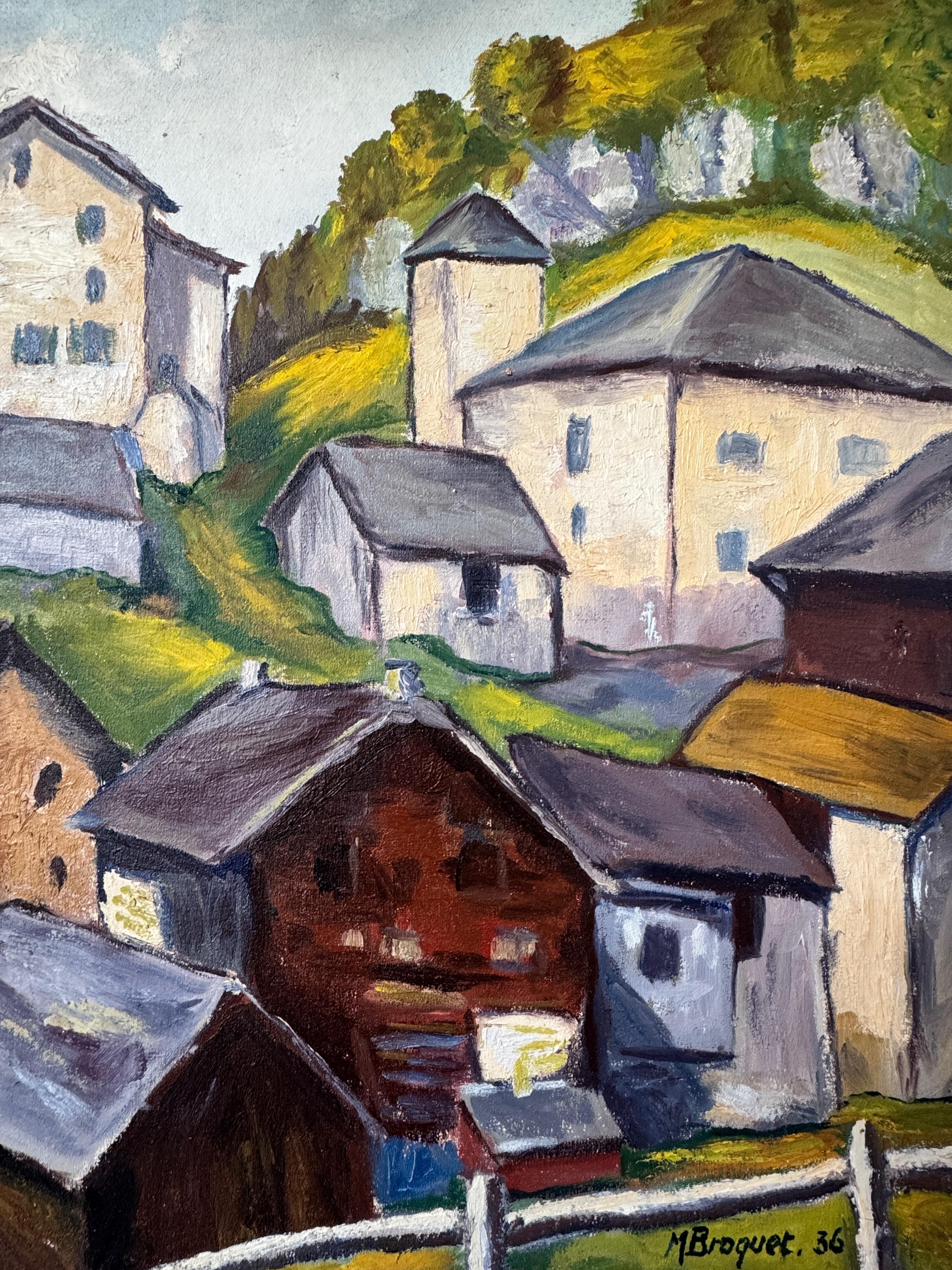 This painting, signed M. Broquet and dated 1936, depicts an Alpine village landscape. The scene shows traditional wooden and stone houses, with sloping roofs, set on a green slope. The buildings, painted in shades of beige, brown and gray, harmonize