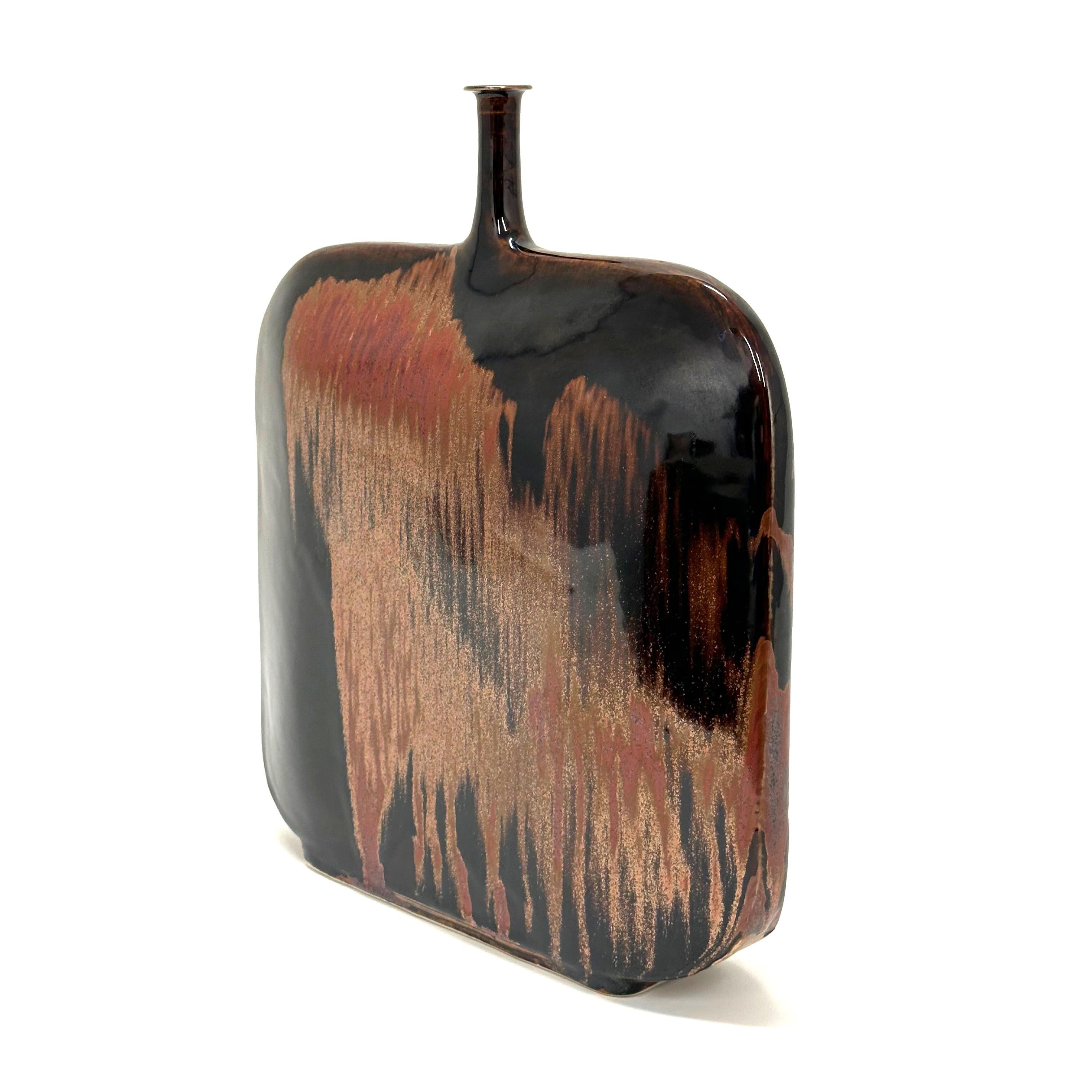 Flask form vase in honan tenmoku glaze by Brother Thomas Bezanson. USA, 1998. Pucker Gallery catalog number, TH1450.

Brother Thomas Bezanson was an internationally renowned ceramic artist and a master of complex glazes and purity of form. Born