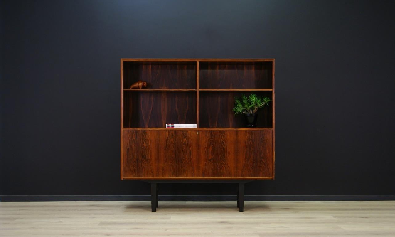 Fantastic bookcase from the 1960s-1970s, Minimalist form - Danish design. Manufactured in the Brouer Møbelfabrik manufacture. Surface finished with rosewood veneer. In the bottom section the bar with mirror and lighting, and a lot of shelves. The