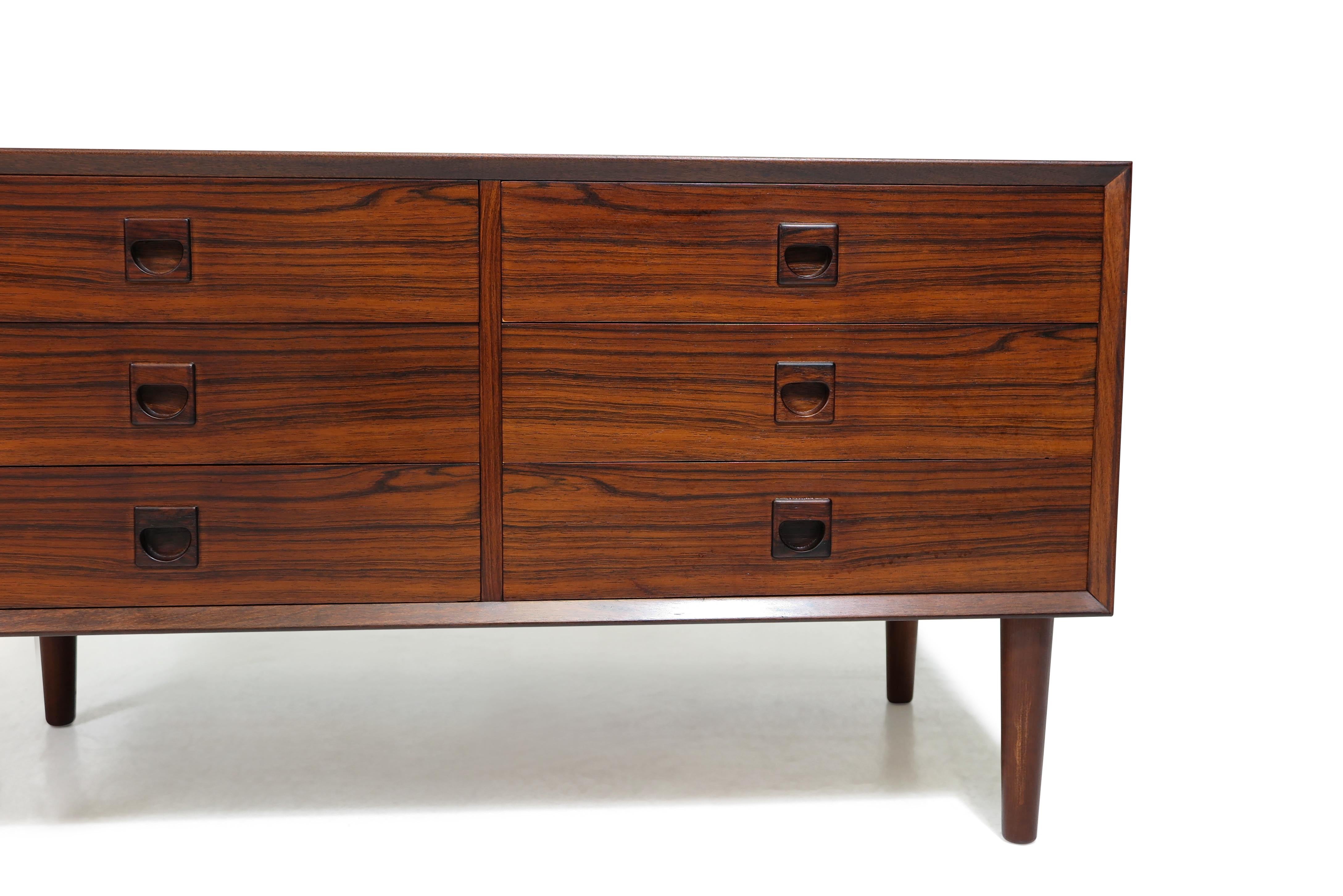 Danish low chest of drawers by Brouer Mobelfabrik, manufactured in Denmark, 1965. Crafted from rosewood, the cabinet features tapered mitered edges and six drawers with square recessed pulls. Interior drawers are crafted from mahogany. Versatile in