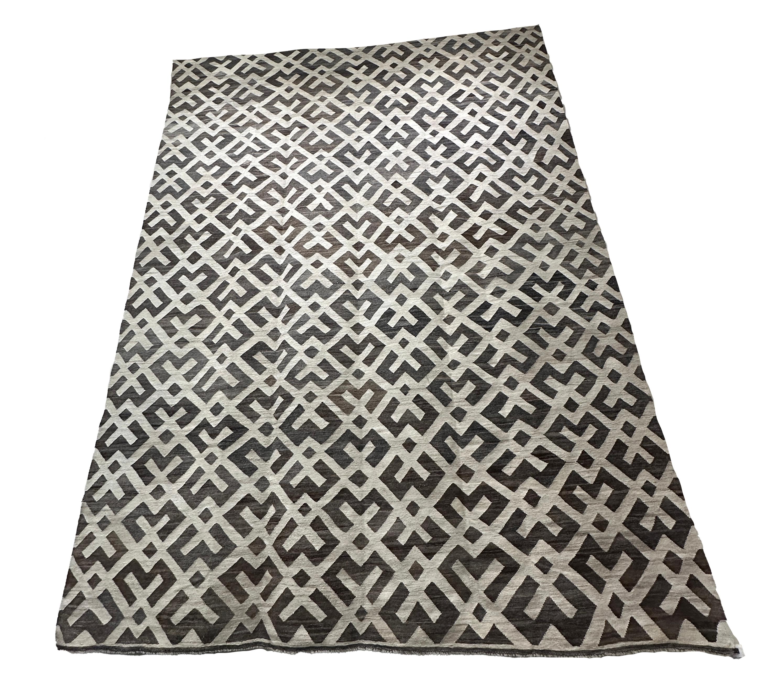 Elevate your living space with this exquisite flat weave kilim rug, featuring a sophisticated brown and cream criss-cross pattern. Hand-woven with meticulous craftsmanship, this rug offers a blend of tradition and modern design, making it a perfect