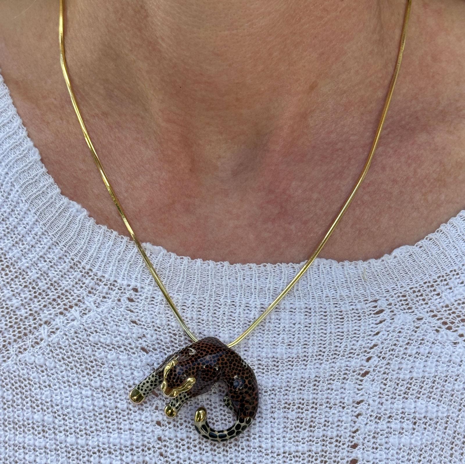 Wildly chic and irresistibly vintage, this 14 karat yellow gold enamel leopard pendant brings bold personality to any collection. Expertly enameled with striking black spots and lifelike detail, the leopard measures approximately 1.25 x 1.50 inches