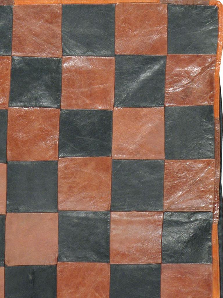 A vintage Italian Art Deco rug from the mid-20th century. A true oddity. Brown and black leather squares alternate in a chessboard (checkerboard) pattern on this totally modern scatter rug handmade in Italy. A very unusual, yet versatile piece for a