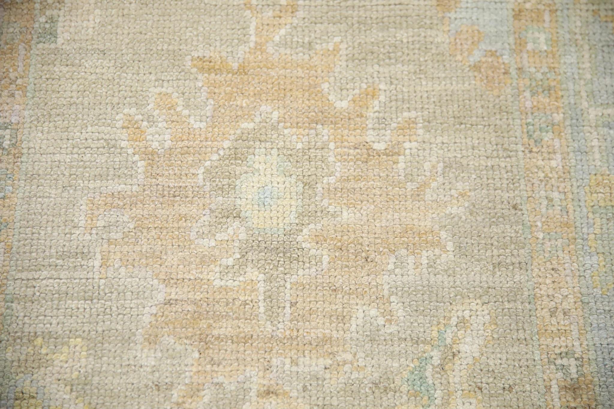 This Turkish oushak rug is a stunning piece of art that has been handwoven using traditional techniques by skilled artisans. The rug features intricate patterns and a soft color palette that is achieved through the use of natural vegetable
