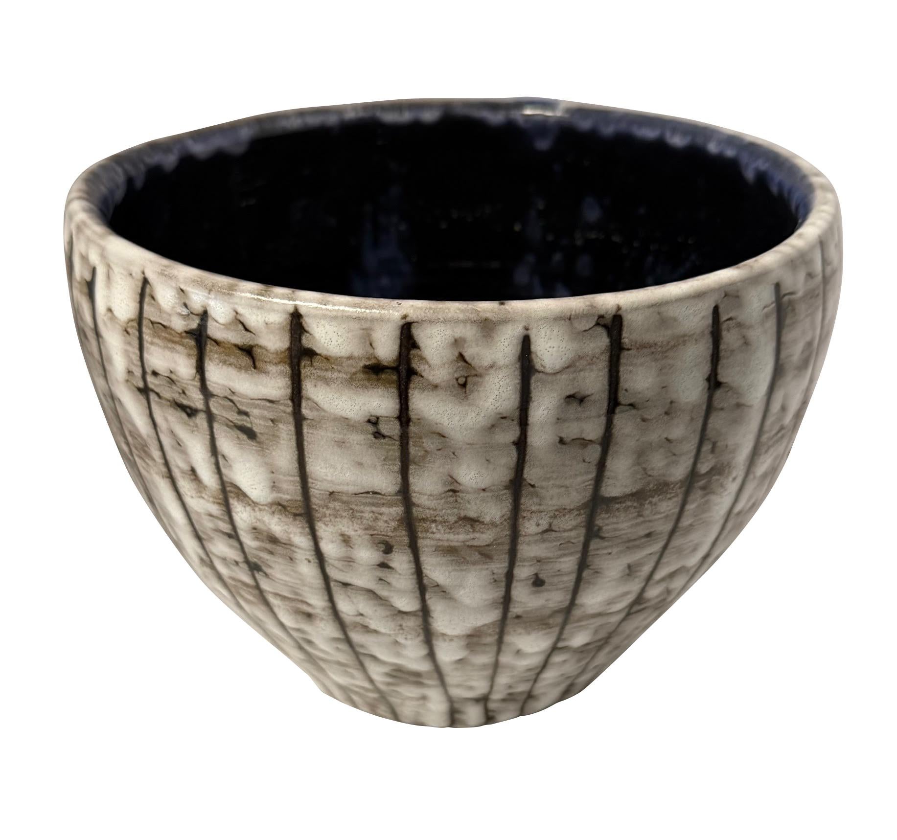 1940's Hungarian Brutalist design brown and cream wide mouth vase.
Vertical lines on the exterior.
Signature cobalt blue interior glaze.
Part of a large collection.