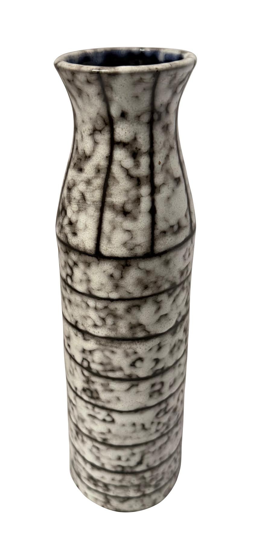 1940's Hungarian Brutalist design brown and cream thin shaped vase.
Vertical lines at the top.
Horizontal lines at the middle and bottom.
Signature cobalt blue interior glaze.
Part of a large collection.