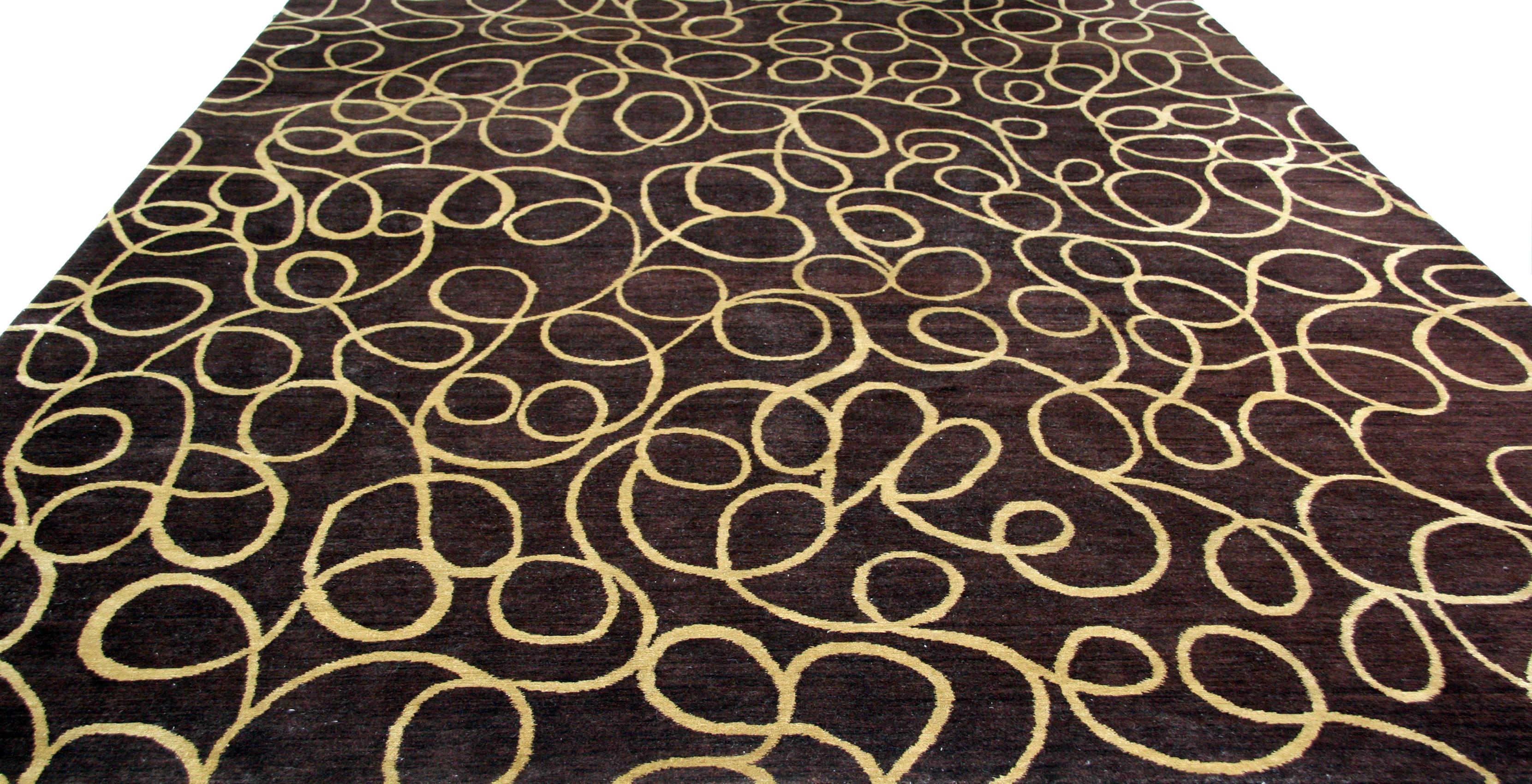 Add a dash of whimsy and warmth to a larger space with this rich chocolate brown wool and silk area rug with cream/gold swirls. The wool silk blend brings durability, a sensuous texture and comfort underfoot. Suitable for home or office. 

Hand