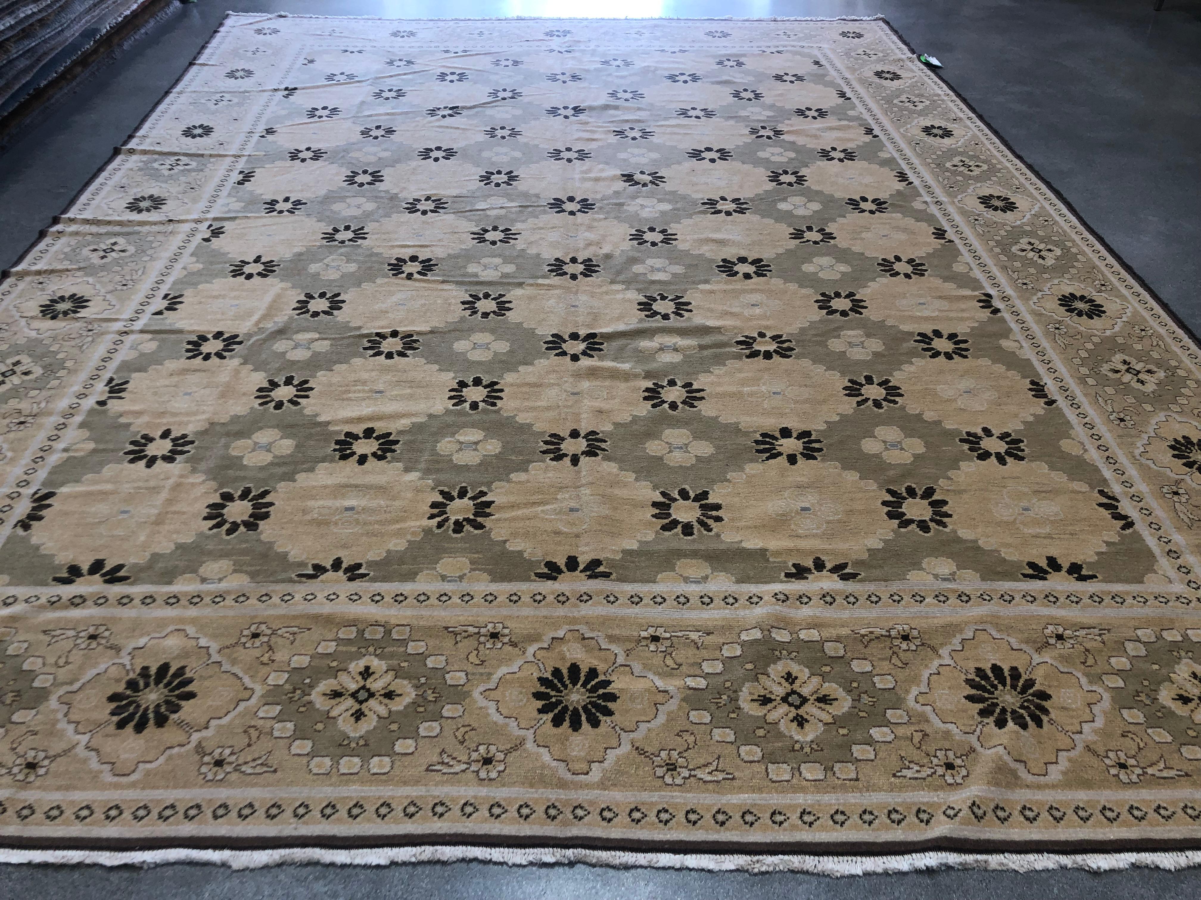 Blossoms and diamonds frame a contrasting pattern of yellow and brown flowers in this variation of a popular style. A taupe backdrop creates a unified look. Hand knotted wool.