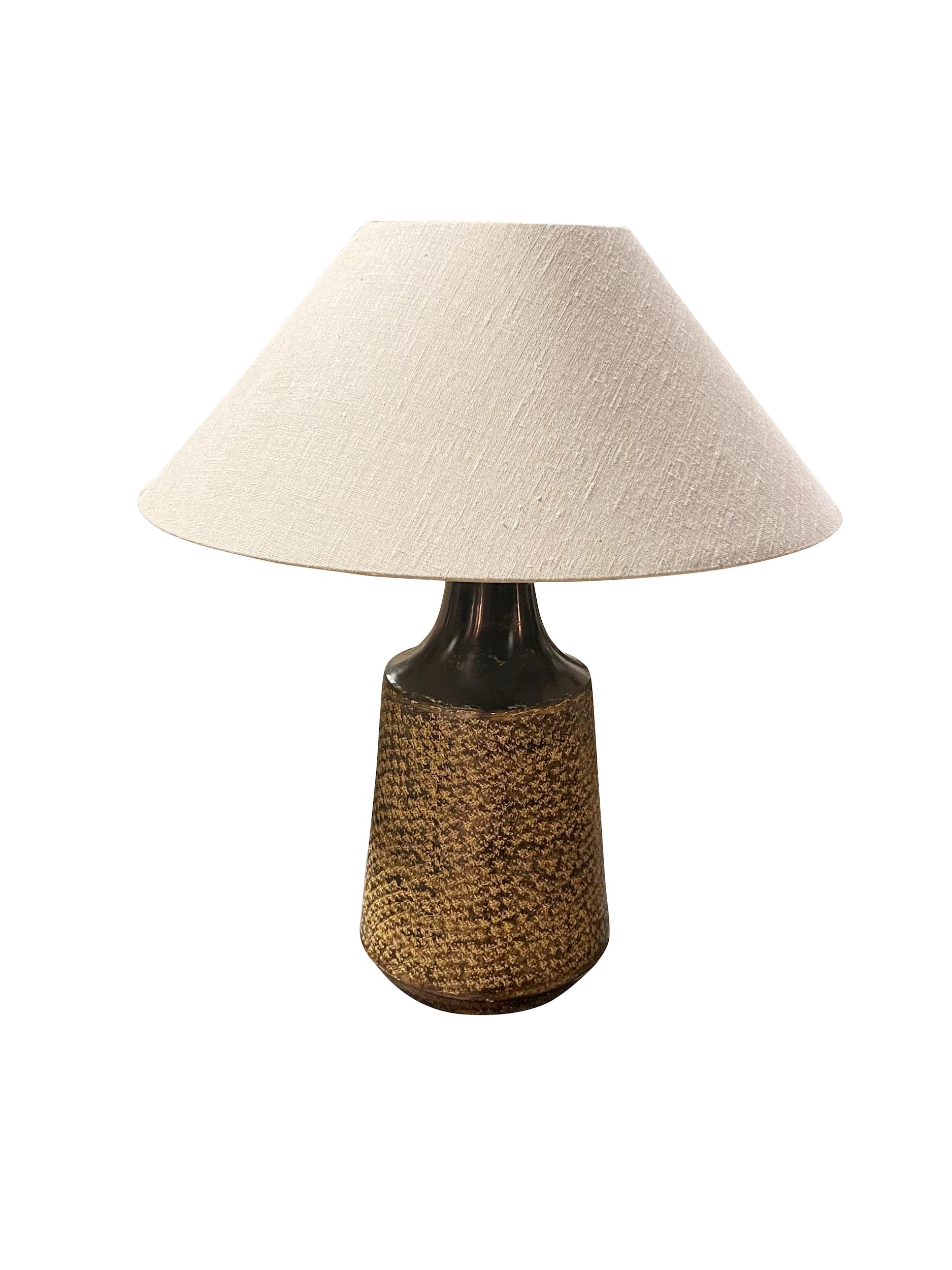 Contemporary Chinese pair textured metal lamps.
Top of base has mottled decorative pattern design.
Bottom of base is solid.
Belgian linen shades included.
Shade diameter 21