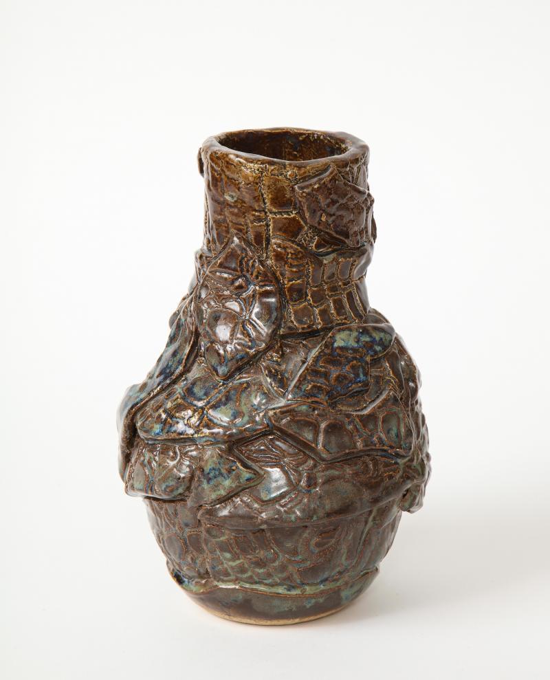 Stunning, irregularly shaped brown ceramic vase in earthen brown, green, and blue tones. Signed on the underside.

