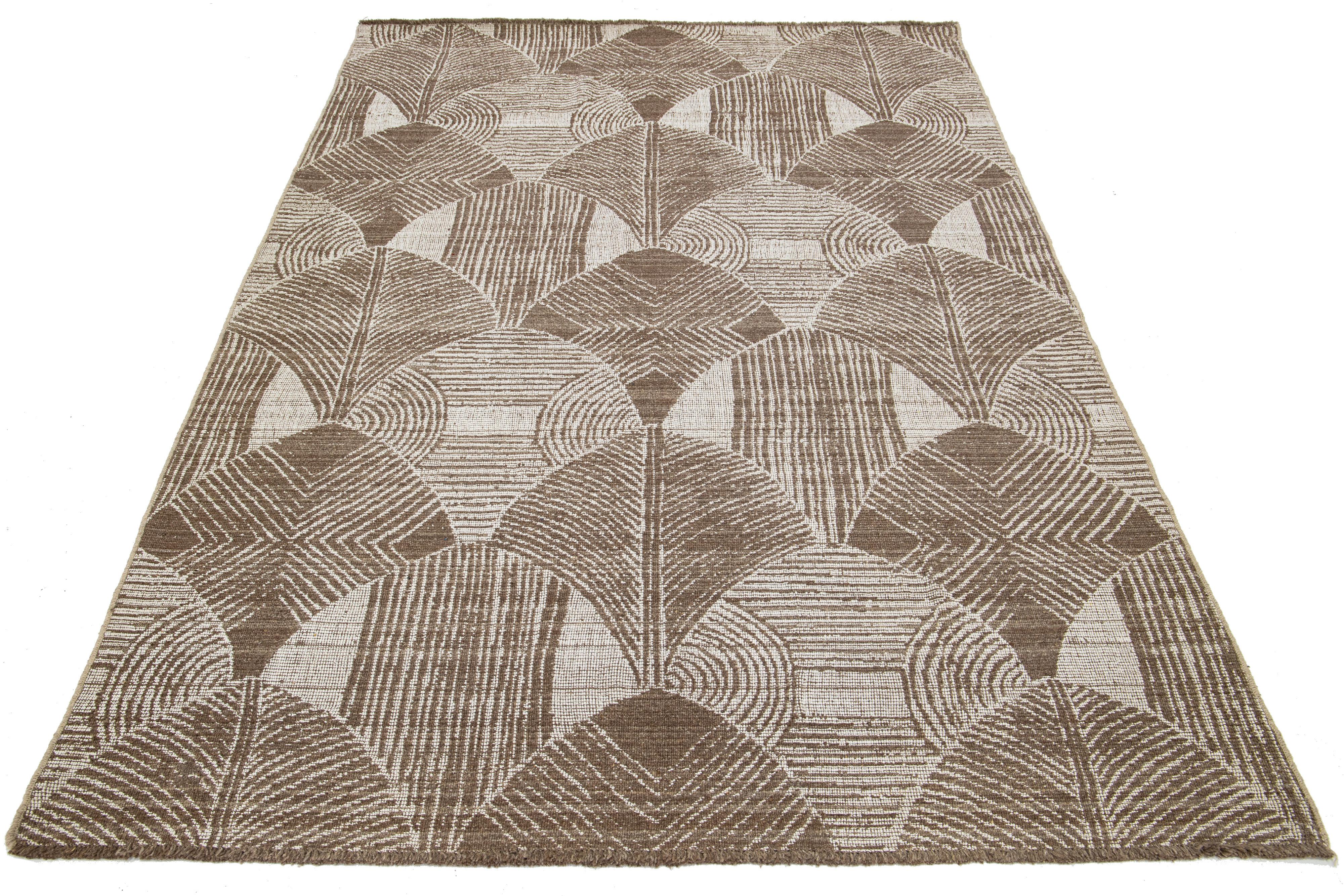 This Modern hand-loom wool rug showcases a stunning beige-taupe field with an all-over abstract design.

This rug measures 6'4