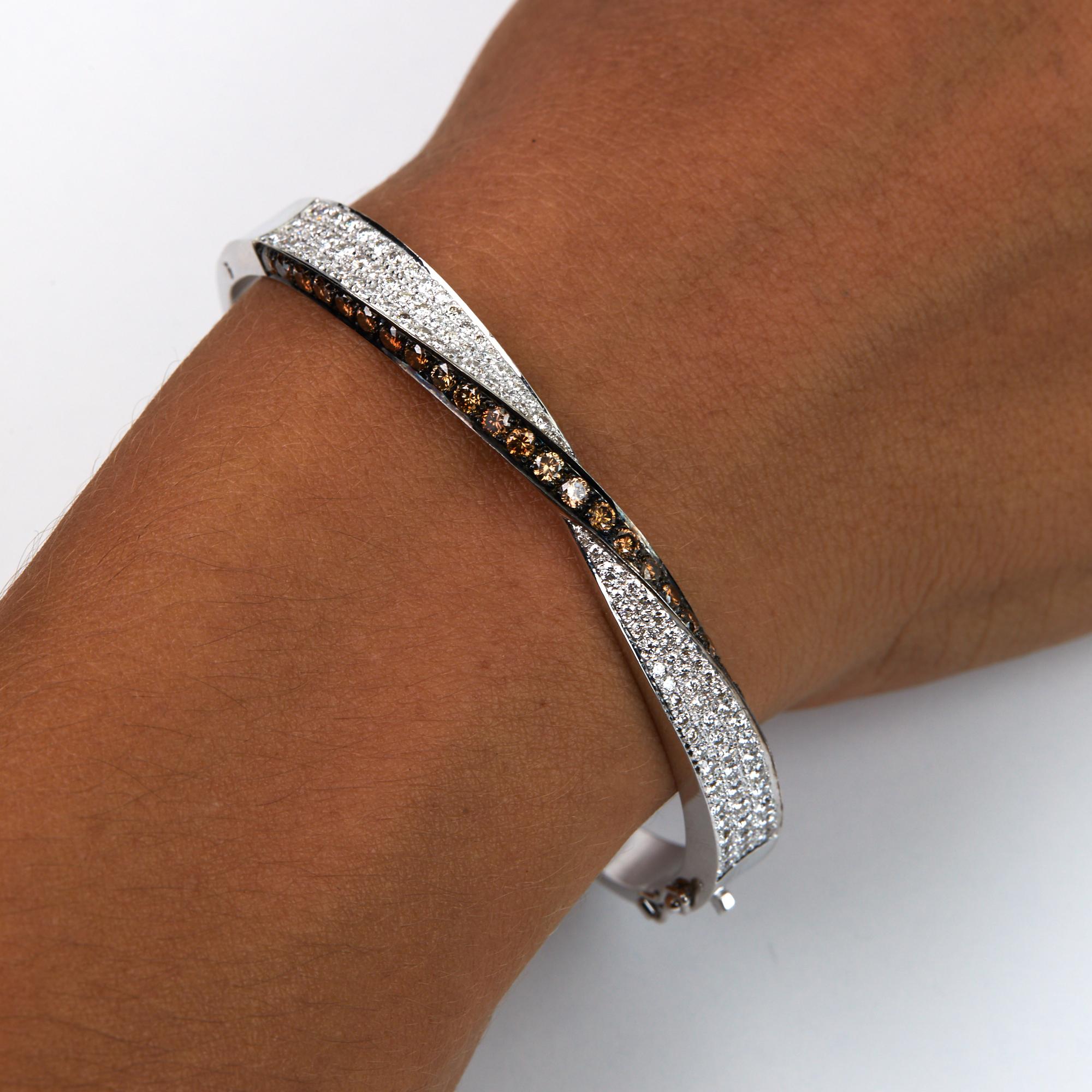 Brown And White Diamond Bangle Bracelet.  This one of a kind Modern Bracelet was made for us in Hong Kong using 1.39 carats of brilliant round cut  fancy brown diamonds and 1.32 carats of brilliant round cut white diamonds.  The white diamonds are