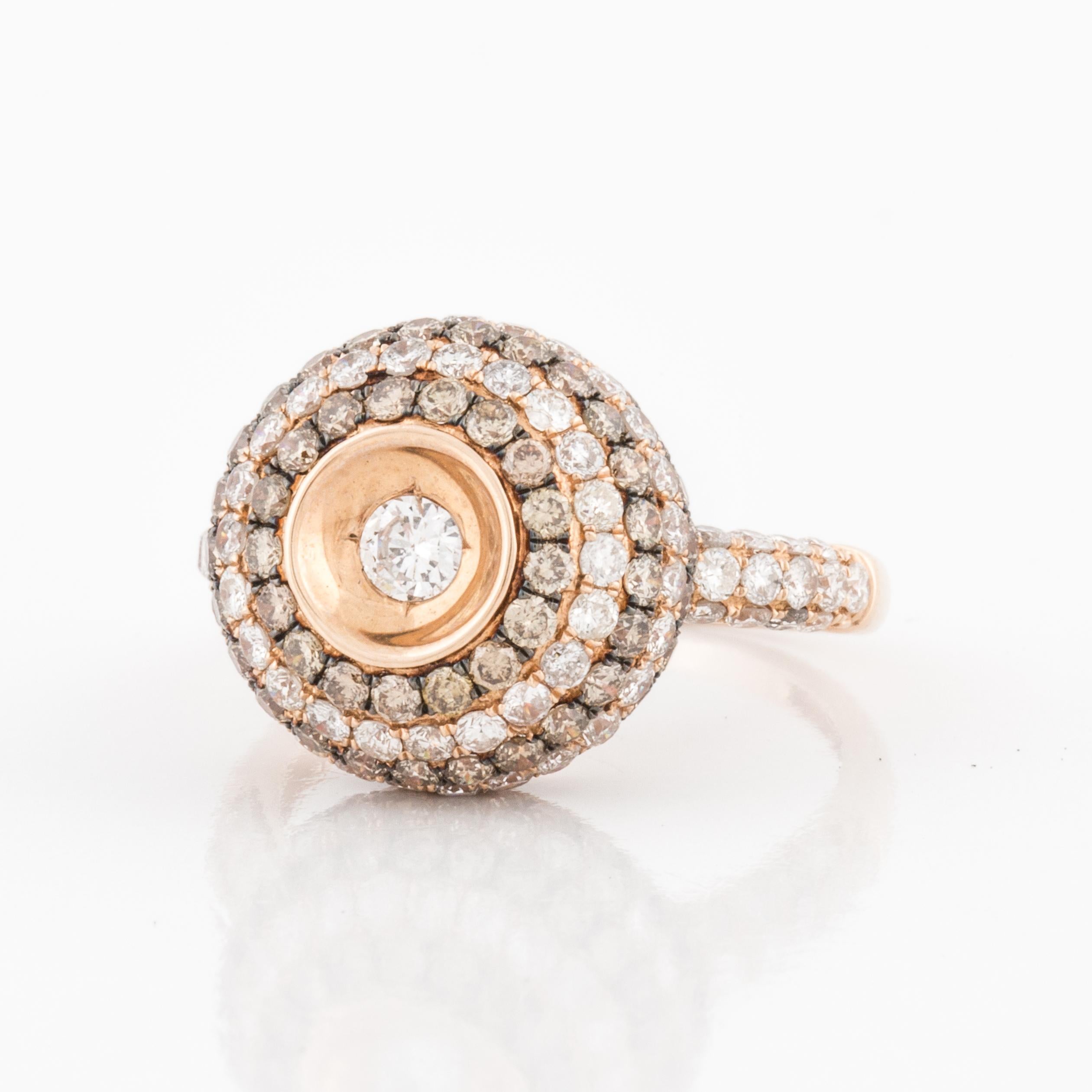 14K rose gold ring with brown and white diamonds.  There are 155 diamonds that total 3.05 carats.  The white diamonds are G-H color and VS2/I1 clarity and the remainder are fancy brown diamonds.  The sphere measures 5/8 inches across and it is 5/16