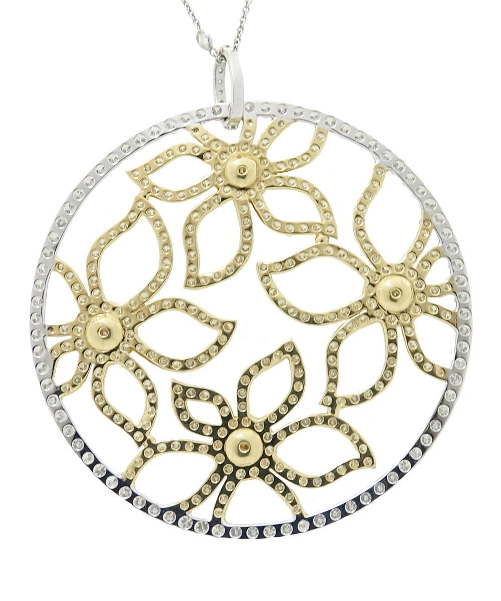   This 18K Yellow and White Gold Pendant Necklace Has Sparkling Natural Colored Diamonds That Make Up A Beautiful Flower Design. These Diamonds Weigh A Total Carat Weight Of 12.63 Carats. This Pendant Is Sure To Make Quite A Statement With It's 2.5