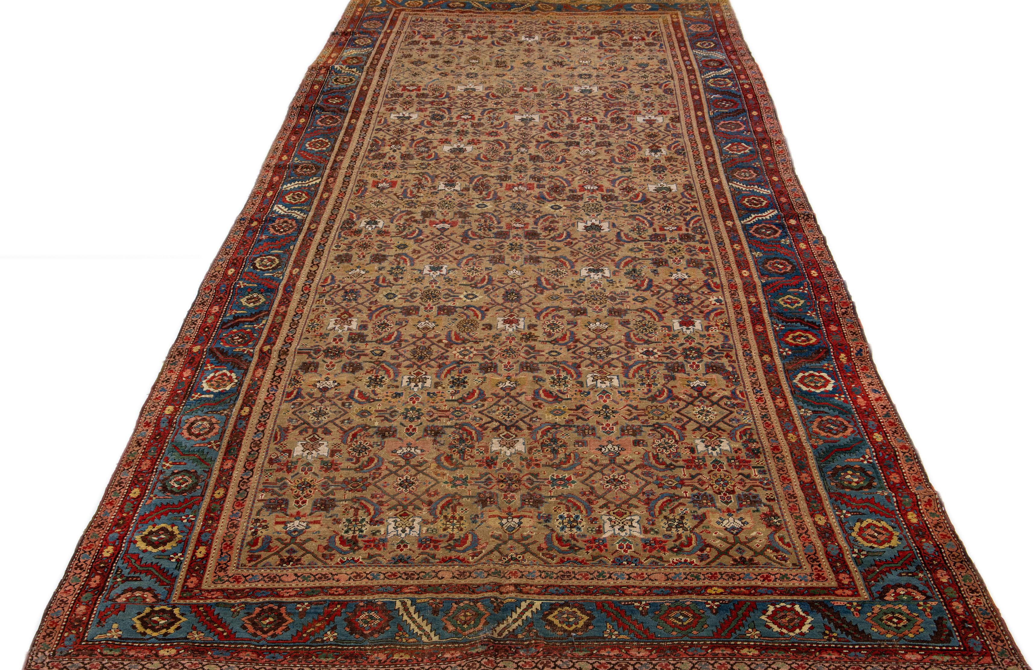 Beautiful antique Bakshaish hand-knotted wool rug with a brown color field. This piece has a blue frame and red accents on a gorgeous Classic all-over floral design.

This rug measures 7' x 16'9