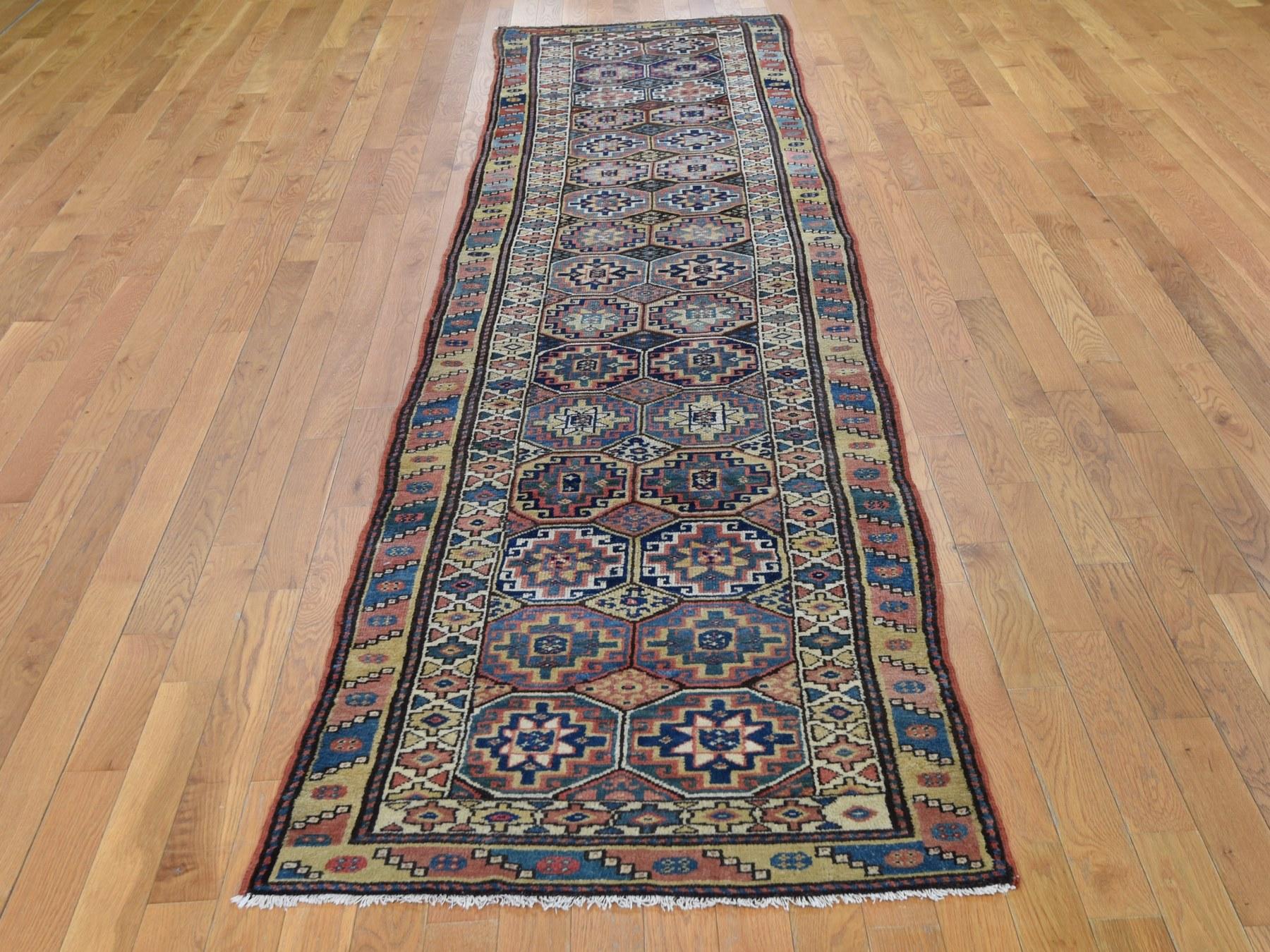 This is a truly genuine one-of-a-kind brown antique Caucasian Kazak double medallion runner hand knotted rug. It has been knotted for months and months in the centuries-old Persian weaving craftsmanship techniques by expert artisans.

Primary