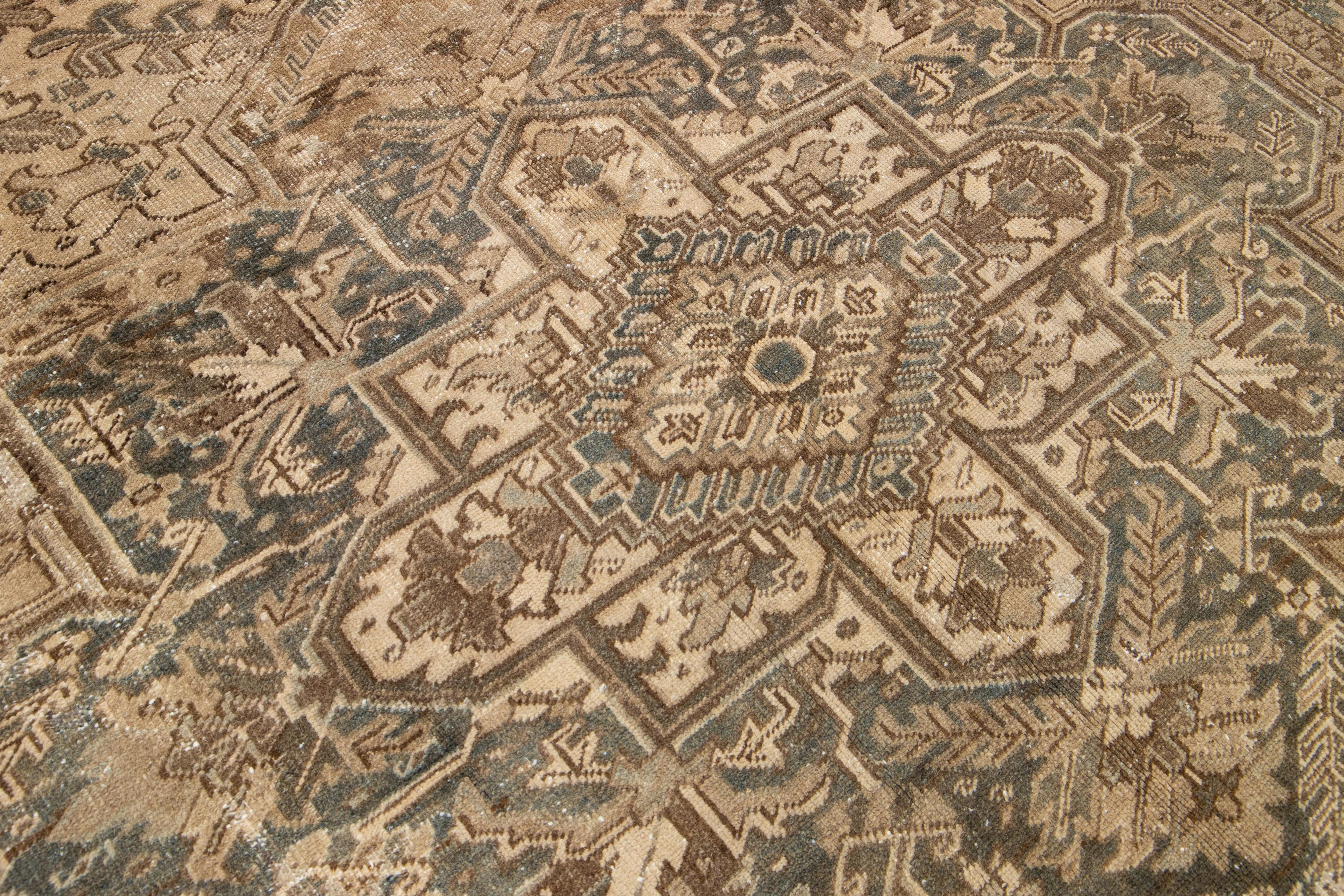 Hand-Knotted Brown Antique Persian Heriz Wool Rug Features a Medallion Motif From The 1920s  For Sale