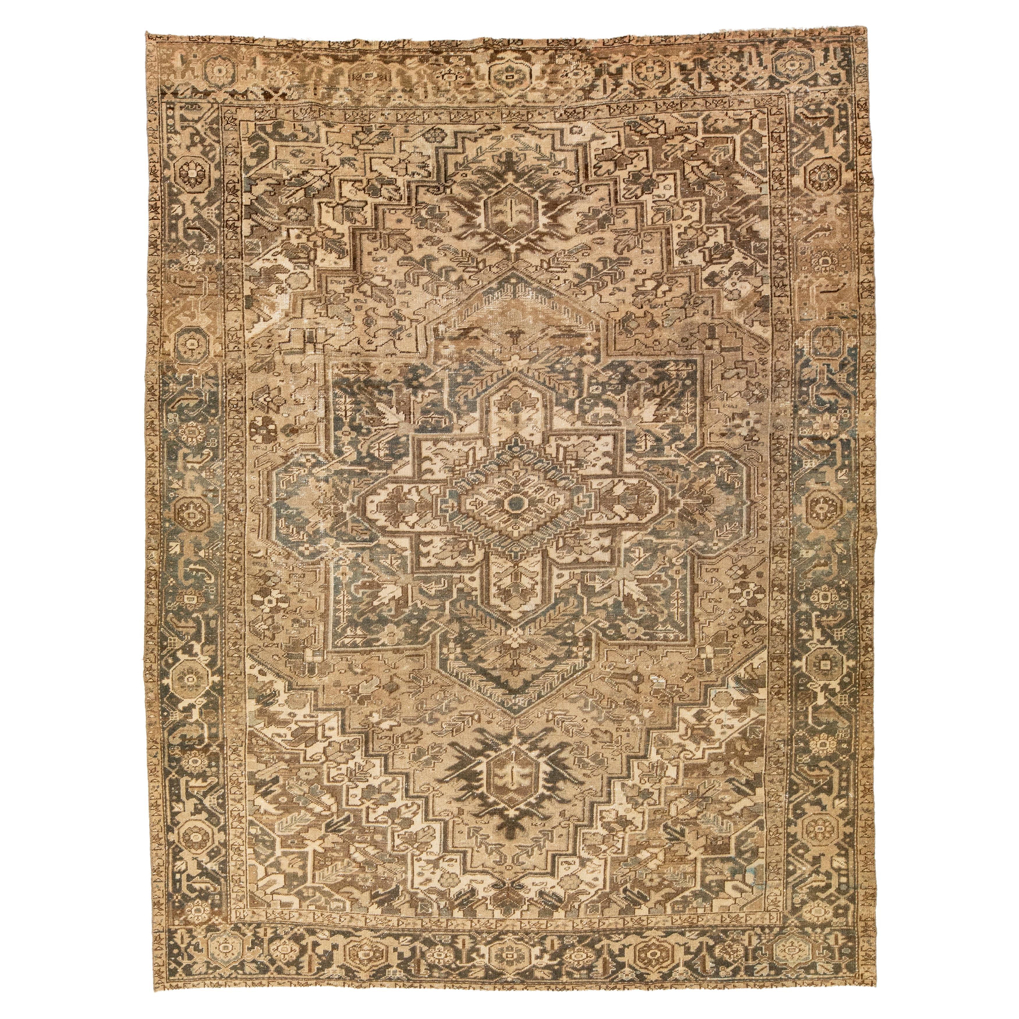 Brown Antique Persian Heriz Wool Rug Features a Medallion Motif From The 1920s  For Sale