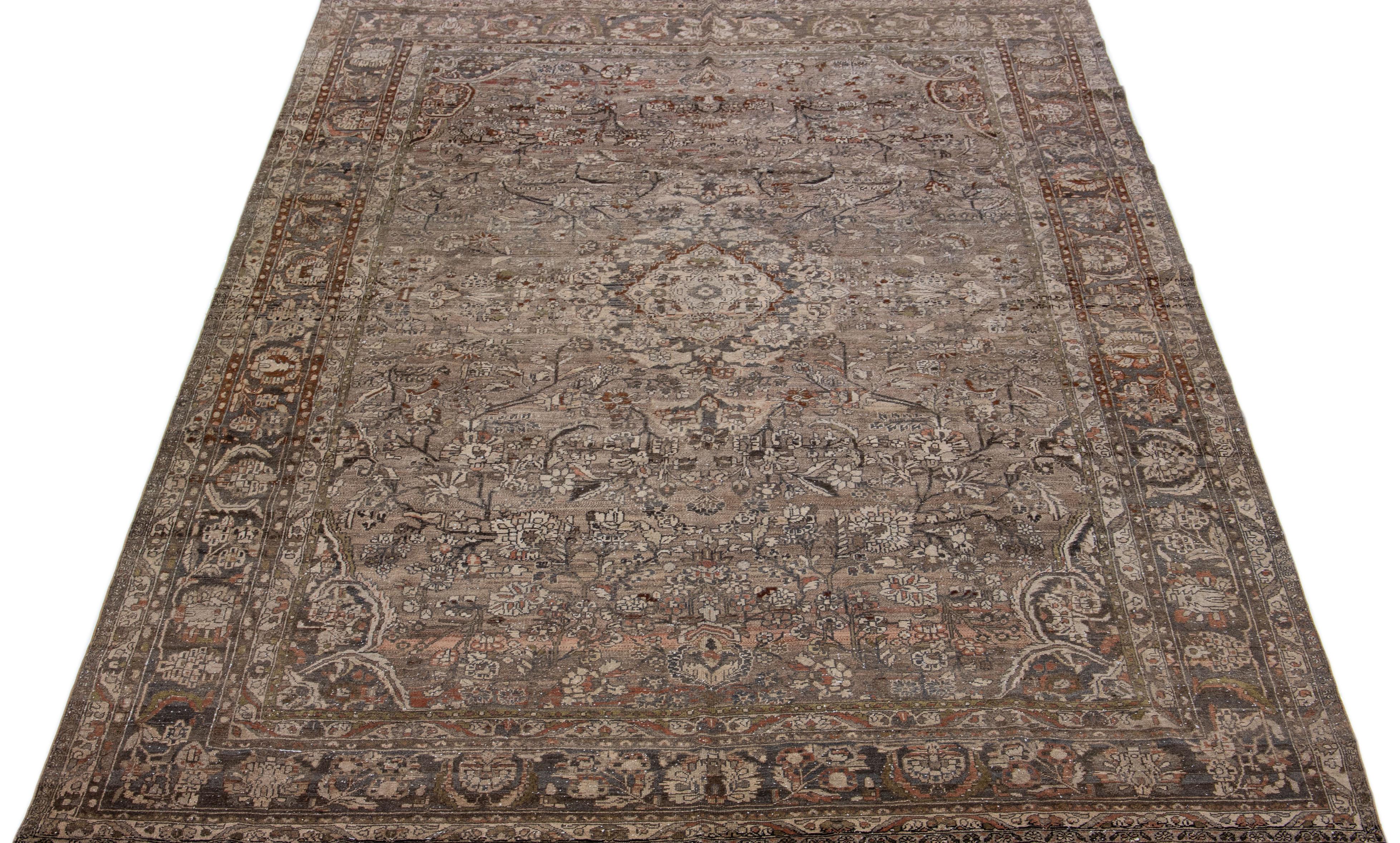 Beautiful hand-knotted antique mahal wool rug with a brown color field. This Persian rug has rust and gray accent colors in an all-over floral design. 

This rug measures: 8'9