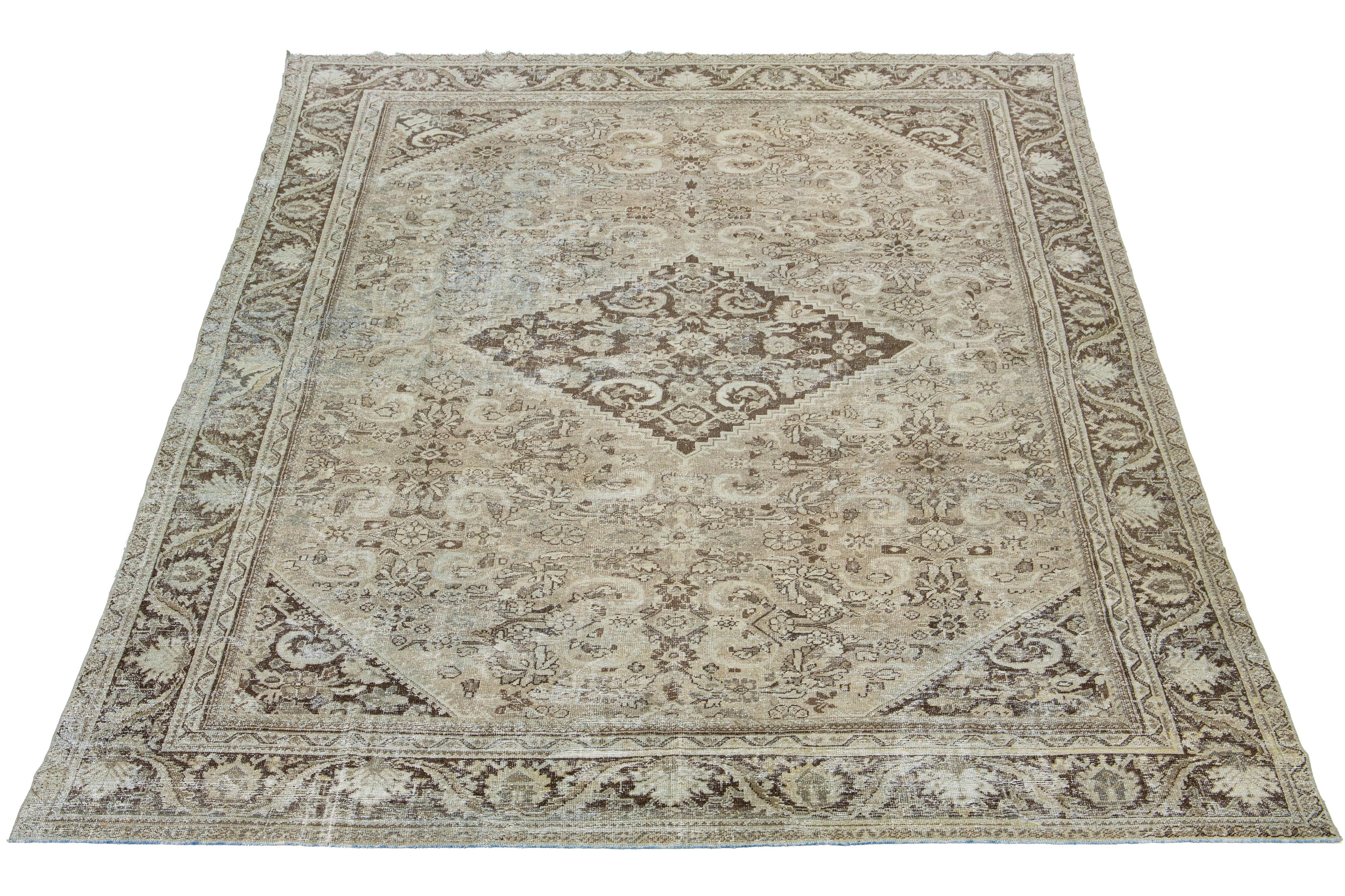 Beautiful Antique Distressed Mahal hand-knotted wool rug with a light brown color field. This Persian rug has classic blue and beige hues throughout the medallion floral motif.

This rug measures 10'3' X 14'8