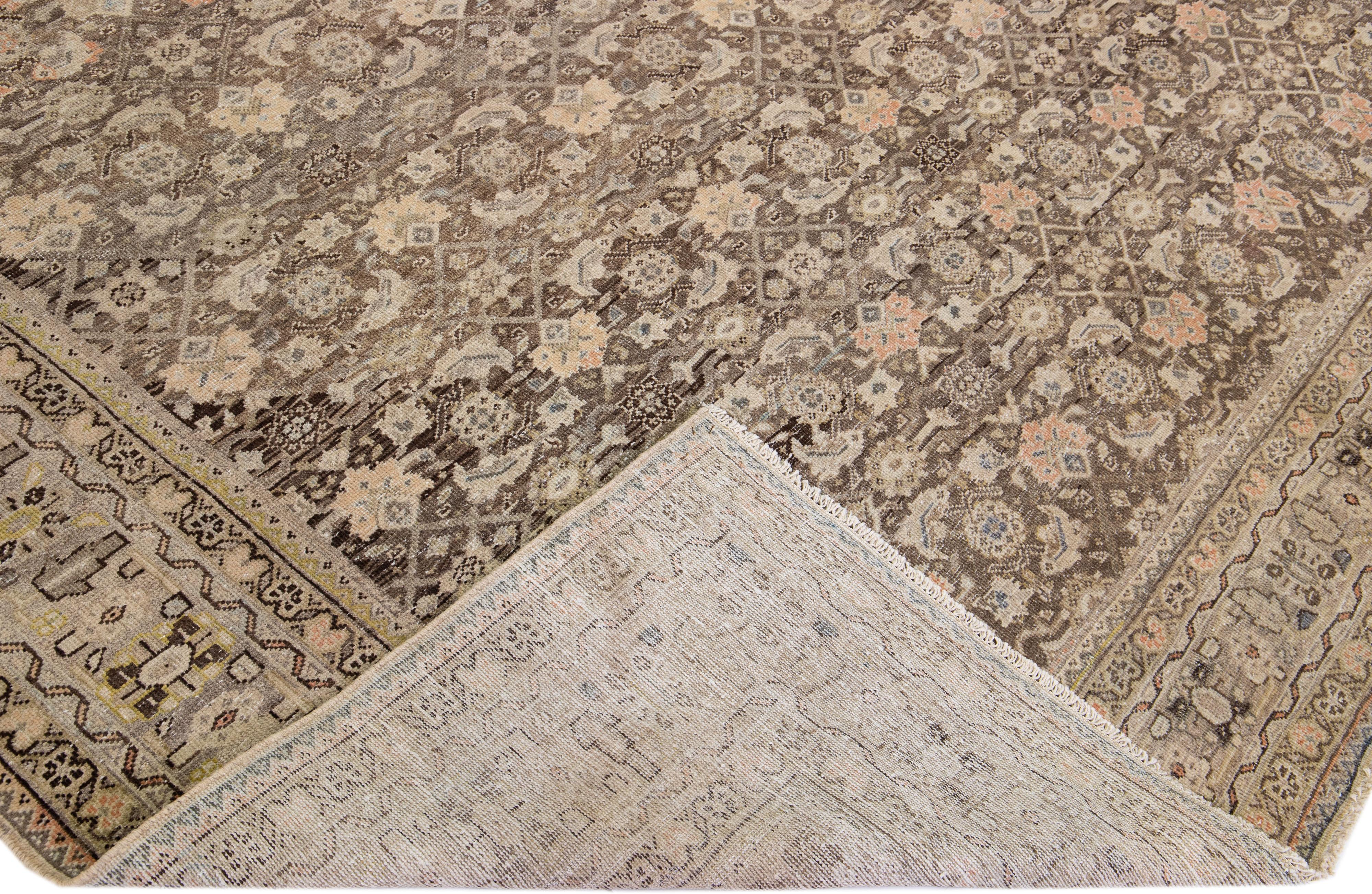 Beautiful antique Malayer hand-knotted wool rug with a brown color field. This Malayer piece has a designed frame with gray, peach, and yellow accents in a gorgeous all-over geometric pattern design.

This rug measures: 9'8