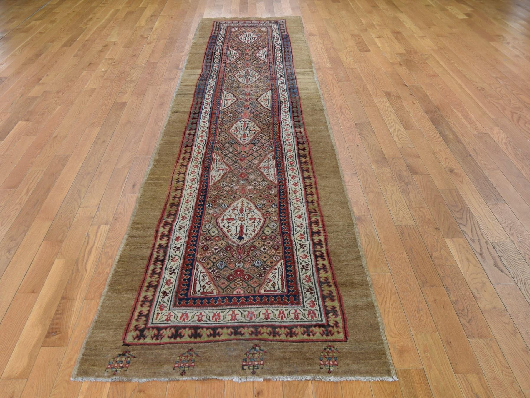 This is a truly genuine one of a kind brown antique Persian Serab Runner camel hair full pile Runner rug. It has been knotted for months and months in the centuries-old Persian weaving craftsmanship techniques by expert artisans.

Primary materials: