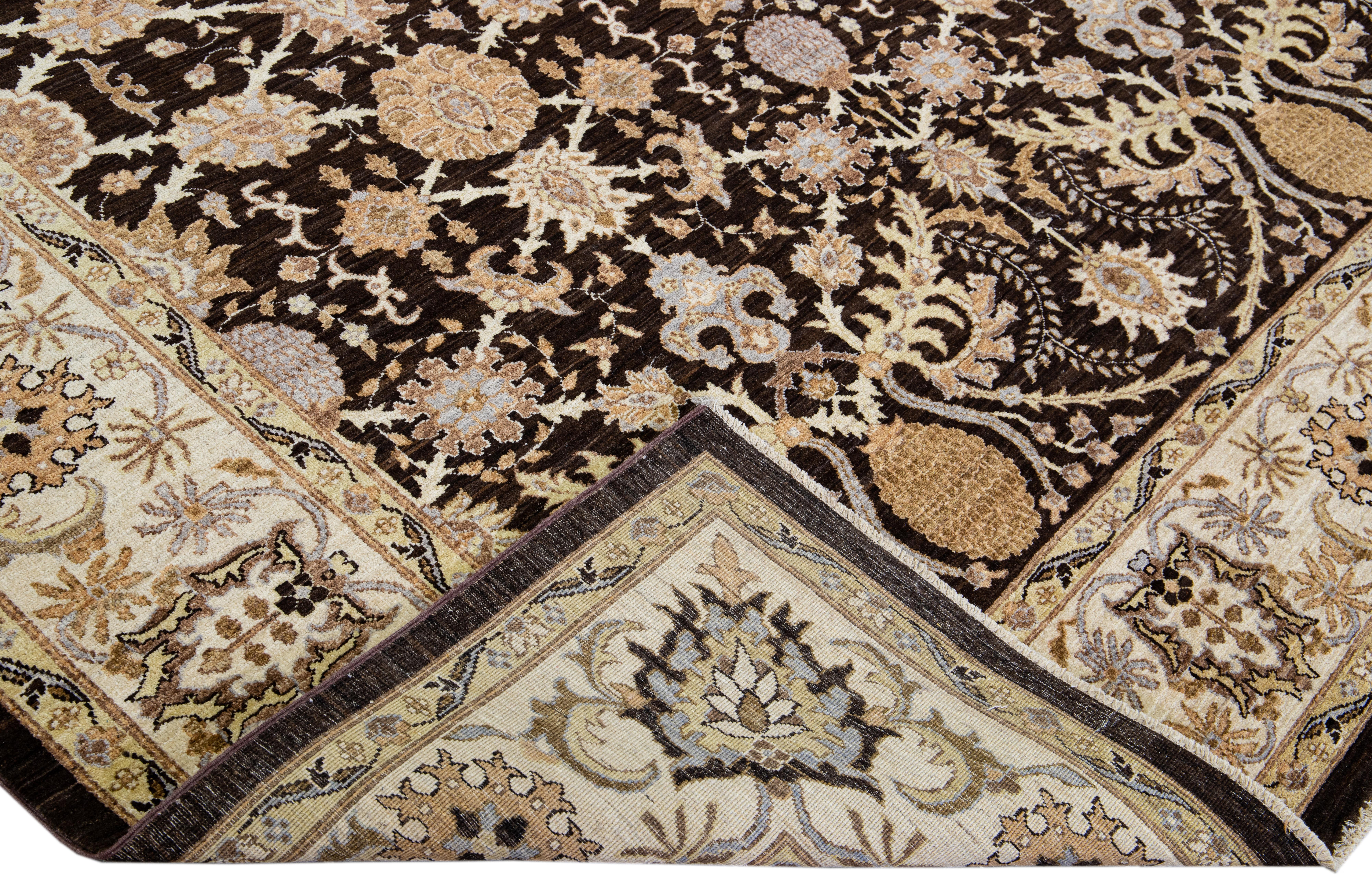 Beautiful hand-knotted antique Peshawar wool rug with the brown field. This Persian rug has a beige frame and multicolor accents featuring an all-over traditional floral design. 

This rug measures 8'3