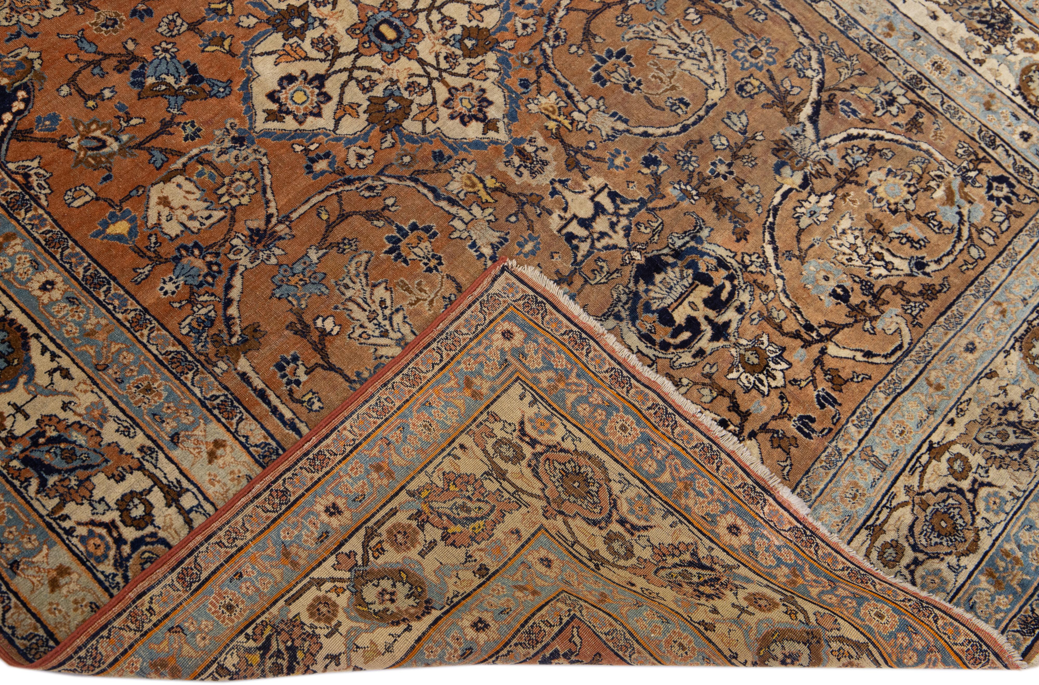 Beautiful antique Tabriz hand-knotted wool rug with the brown field. This Persian piece has a beige frame and blue accents in an all-over Shab Abbasi design. 

This rug measures: 4'6