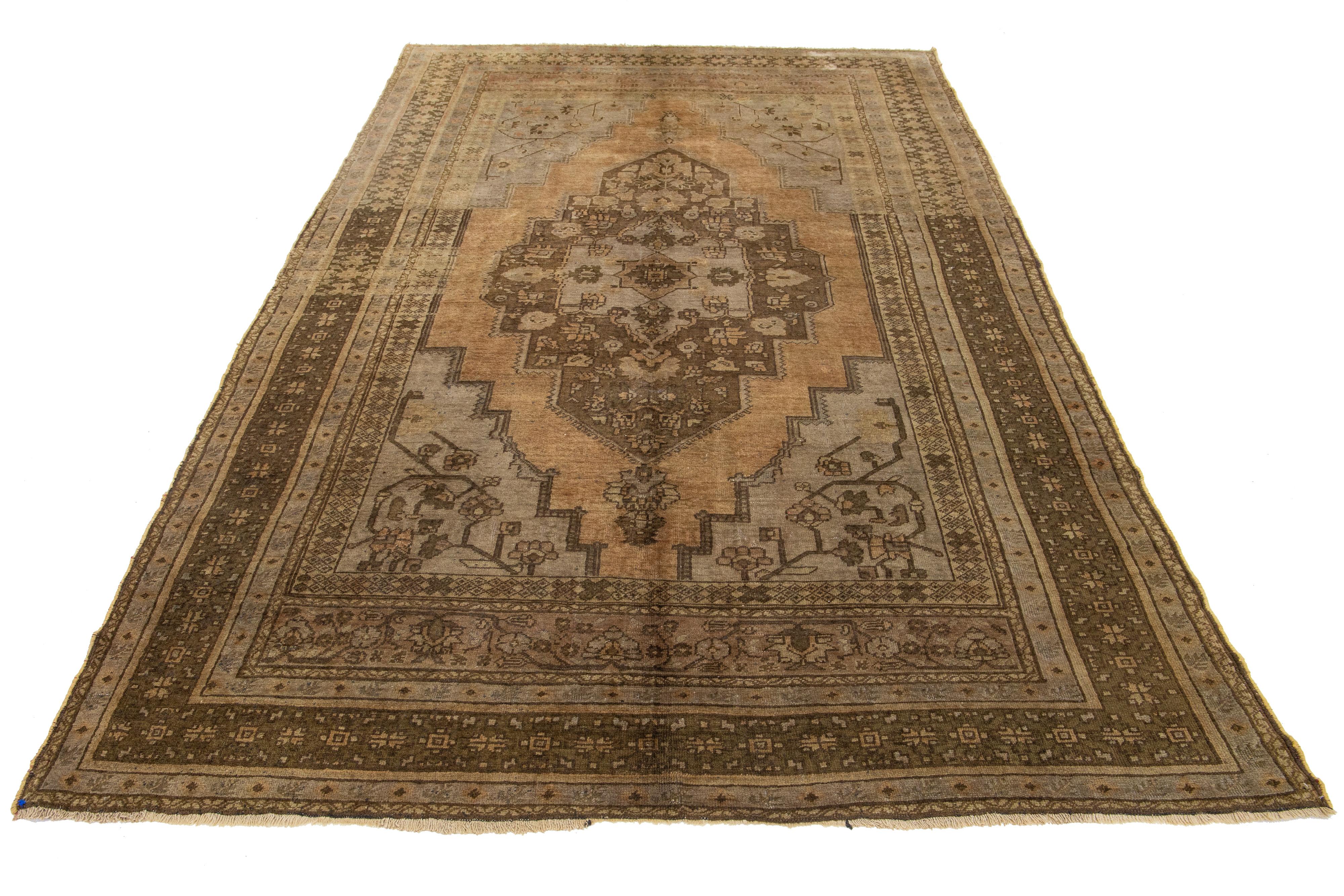 Beautiful Antique Turkish Khotan hand-knotted wool rug with a light brown color field. This Khotan has multicolor accents in a gorgeous all-over medallion floral motif.

This runner measures 7'1