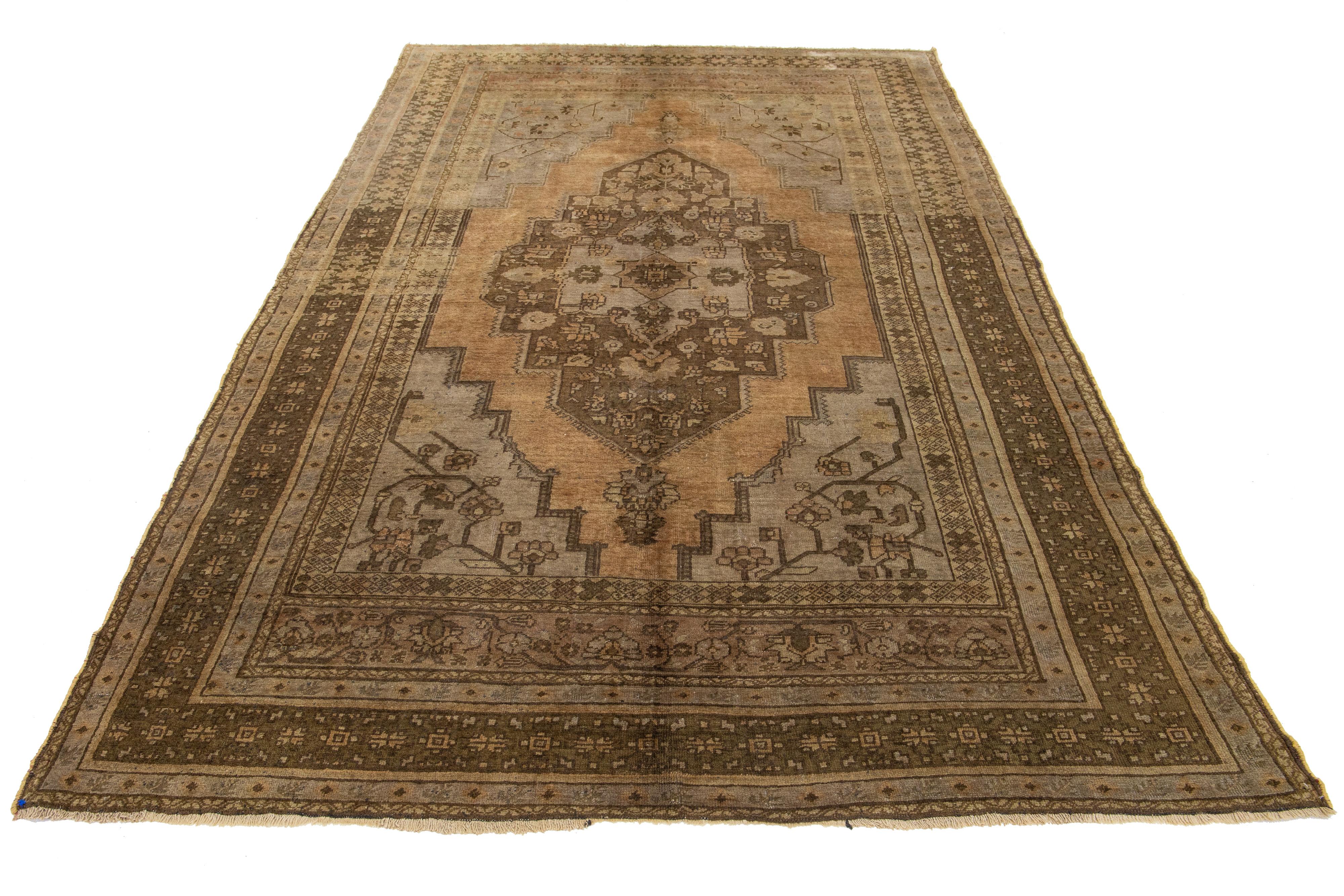 Beautiful Antique Turkish Khotan hand-knotted wool rug with a light brown color field. This Khotan has multicolor accents in a gorgeous all-over medallion floral motif.

This runner measures 7'1