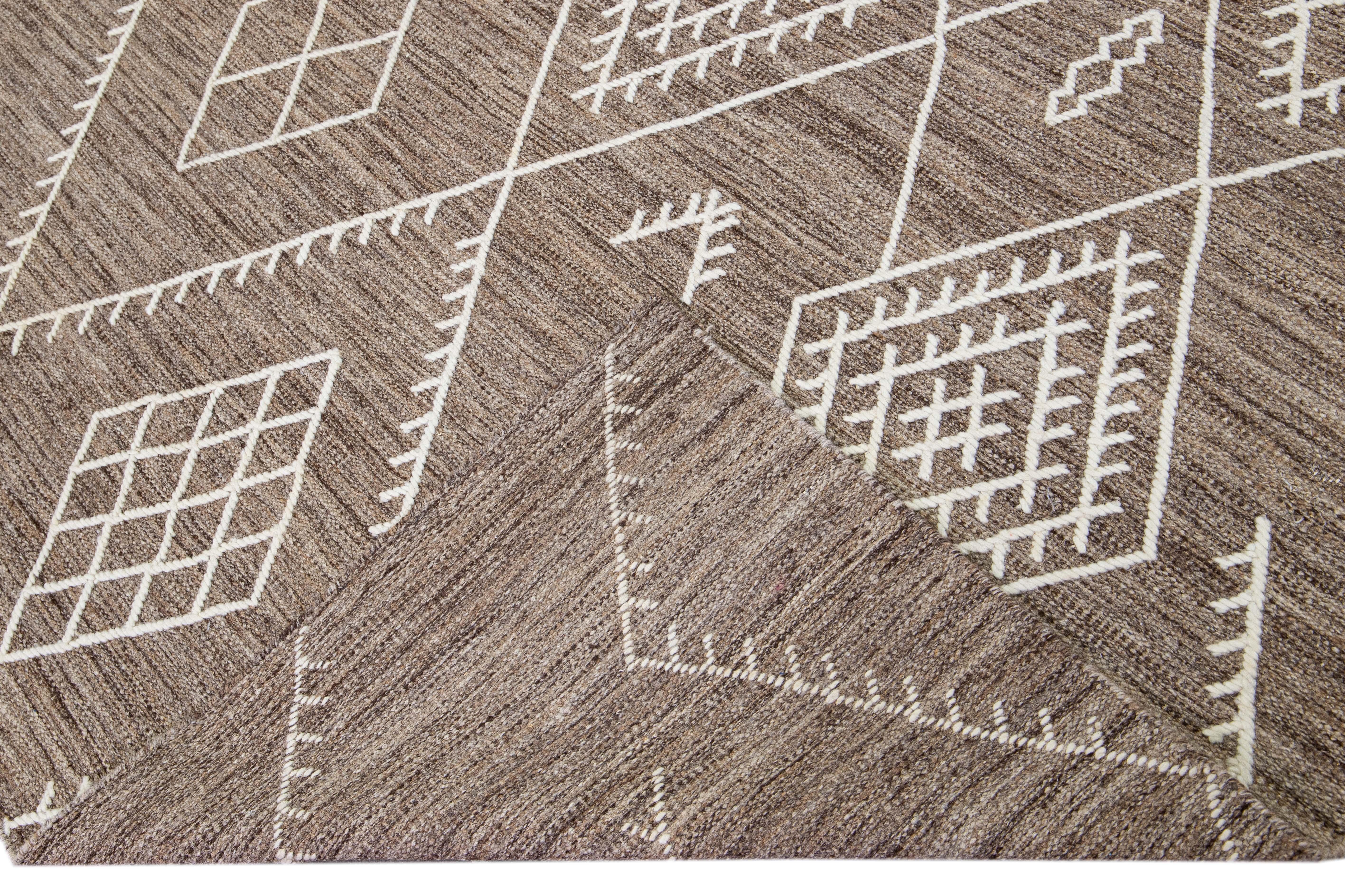 Schöner handgefertigter Kelimteppich aus Wolle mit braunem Feld. Dieser moderne Flachgewebe-Teppich aus unserer Nantucket-Kollektion hat elfenbeinfarbene Akzente und zeichnet sich durch ein wunderschönes geometrisches Küstendesign im Allover-Design