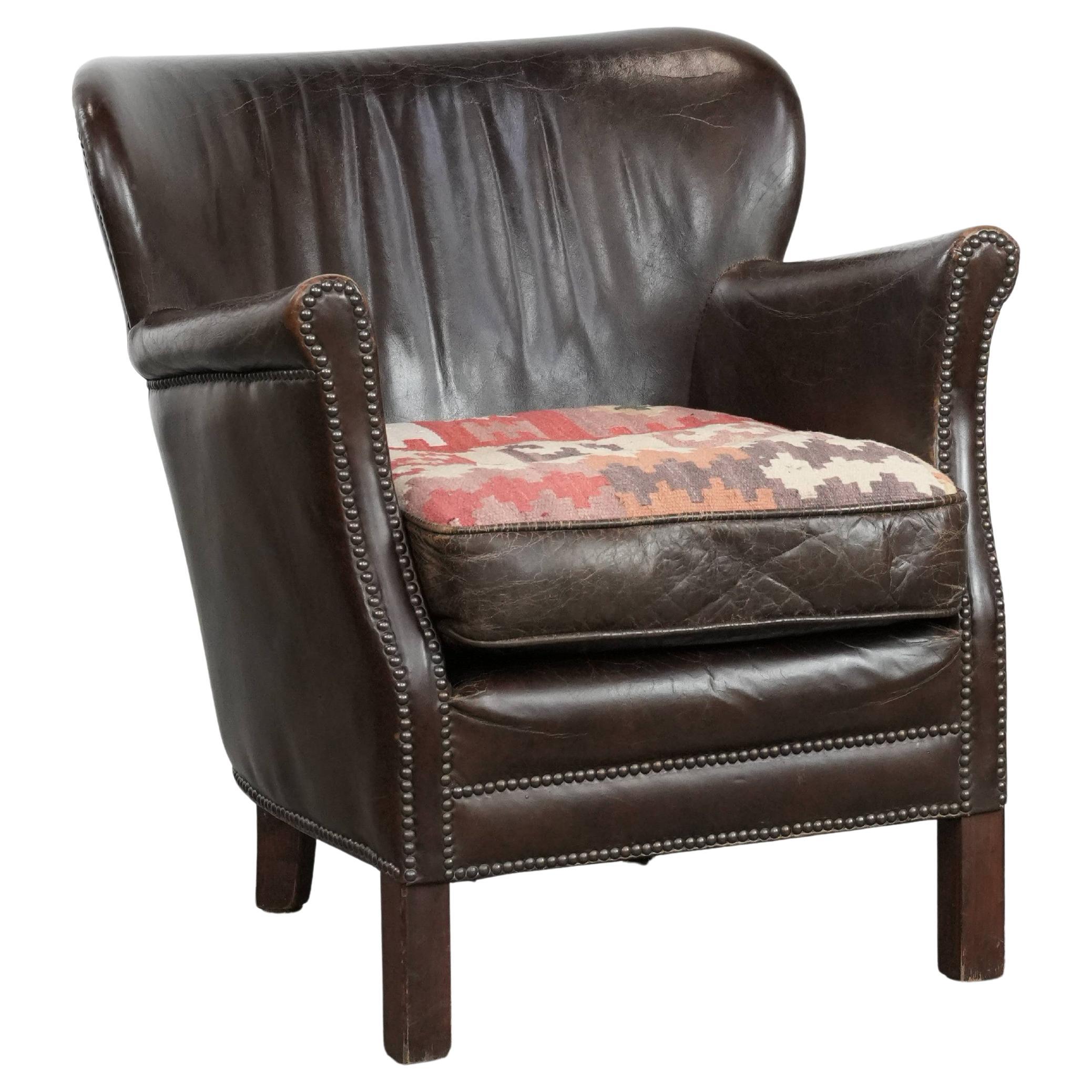 Brown armchair made of cowhide leather with a reversible Kilim seat cushion For Sale