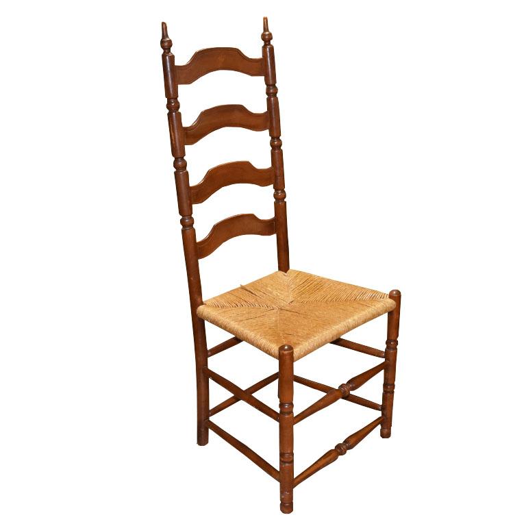 A tall wood arts and crafts style ladder back dining chair. With a square natural fiber woven seat, and a tall racked back, this chair will be a fabulous addition to a dining room, or as a side chair. 

Dimensions:
19