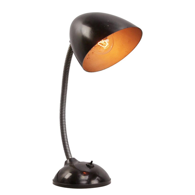 Dark brown Bakelite desk lamp
Gooseneck arm
Black cotton flex, plug and switch in base

Weight: 1.60 kg / 3.5 lb

Priced per individual item. All lamps have been made suitable by international standards for incandescent light bulbs,