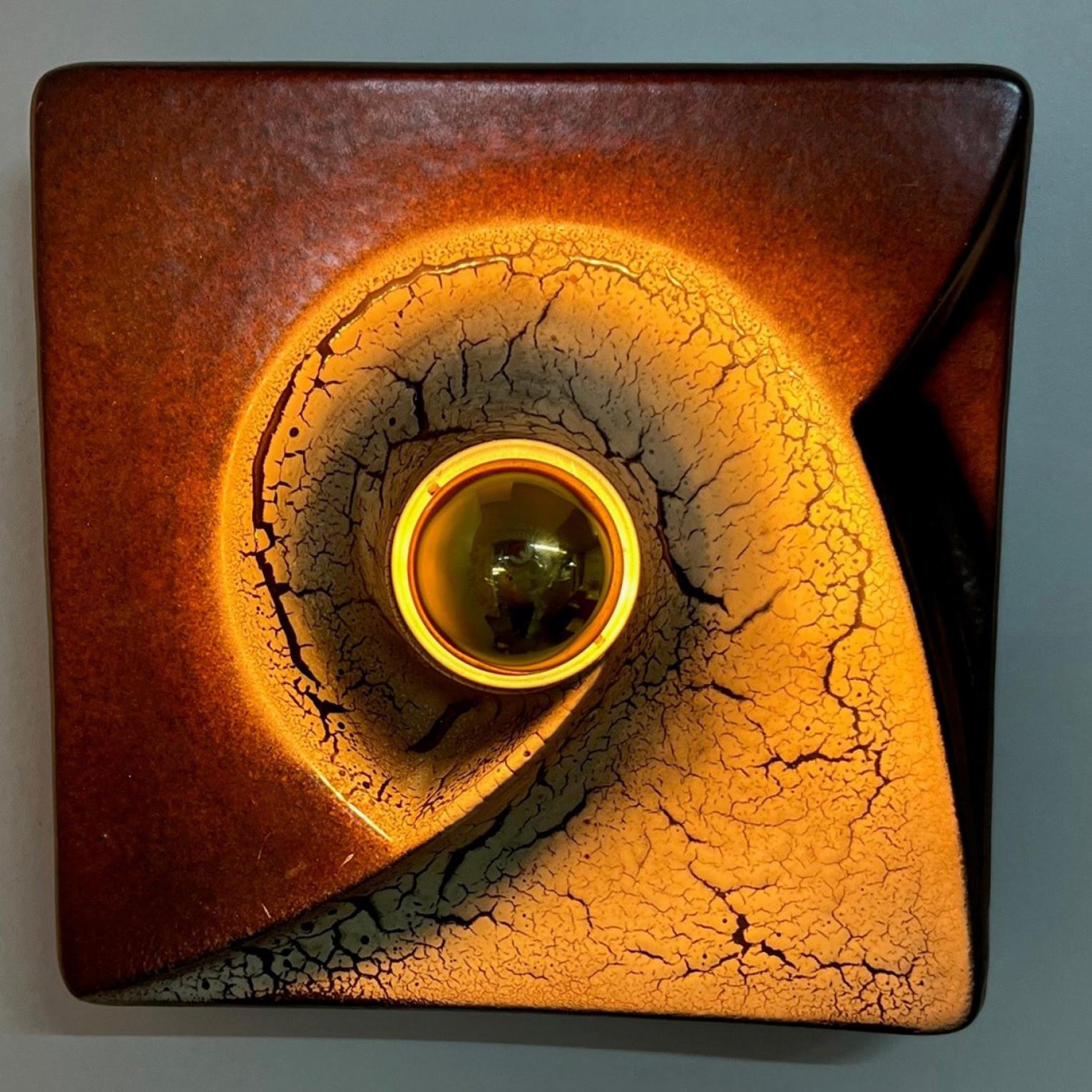 Brown beige square ceramic wall lights in Fat Lava style. Manufactured by Hustadt Leuchten Keramik, Germany in the 1970s.

The style of the glaze is called 'Fat Lava'. Which means the glaze is thick on some parts, like lava.
A typical way to finish